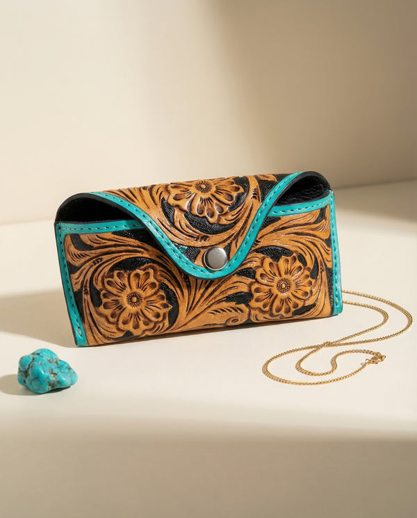 Tan and black two-tone hand-tooled leather sunglasses case with turquoise edge piping by Ya Qalbi