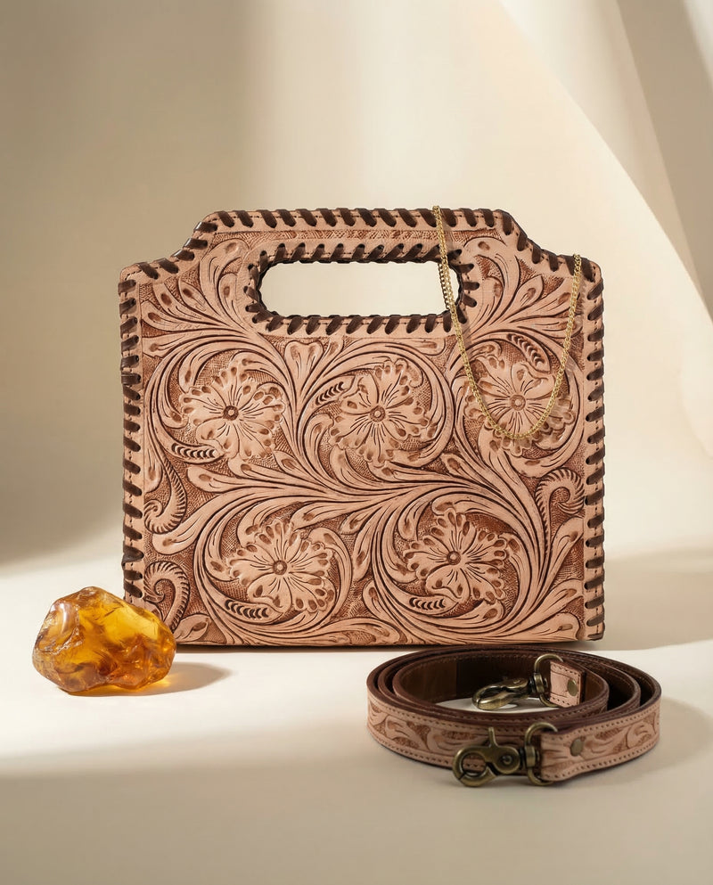 Hand-tooled leather handbag with dense floral carving by Ya Qalbi