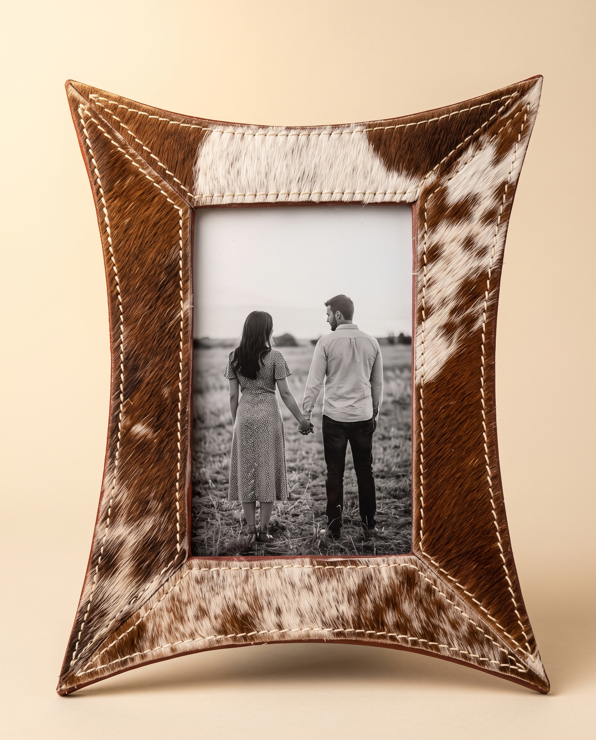 Brown and white curved hair-on leather photo frame with photo, front view