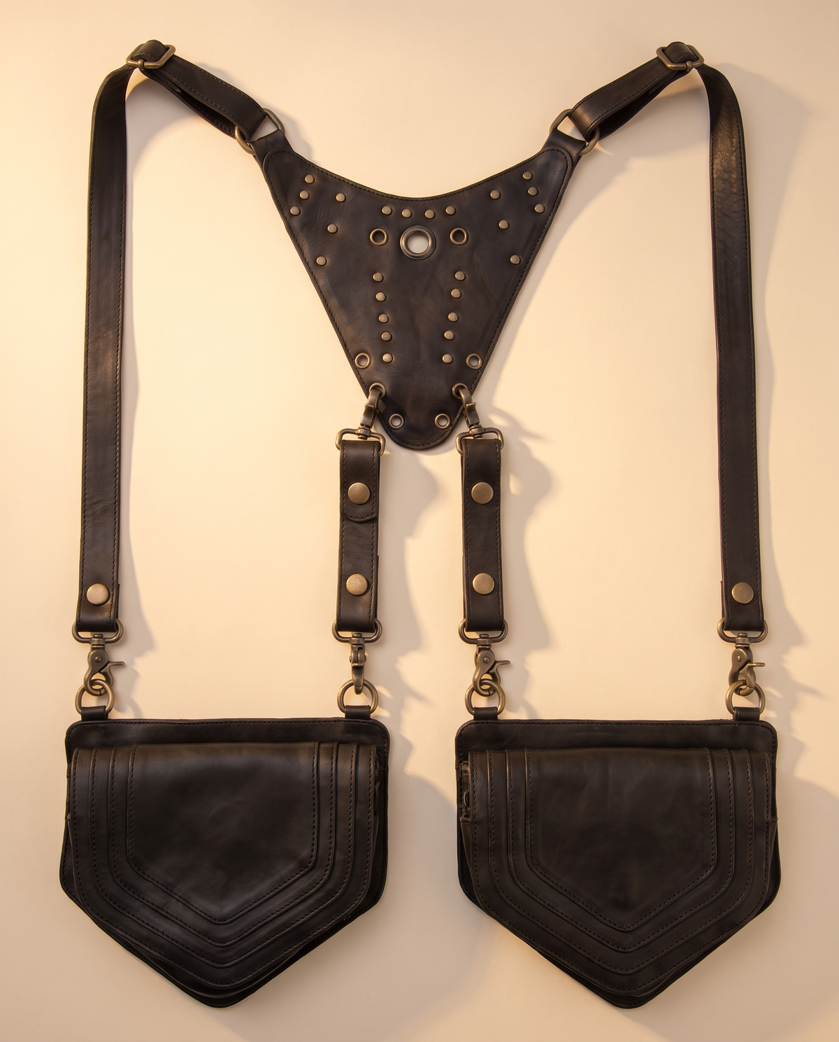 Black leather harness bag with two detachable pouches, front view, by Ya Qalbi