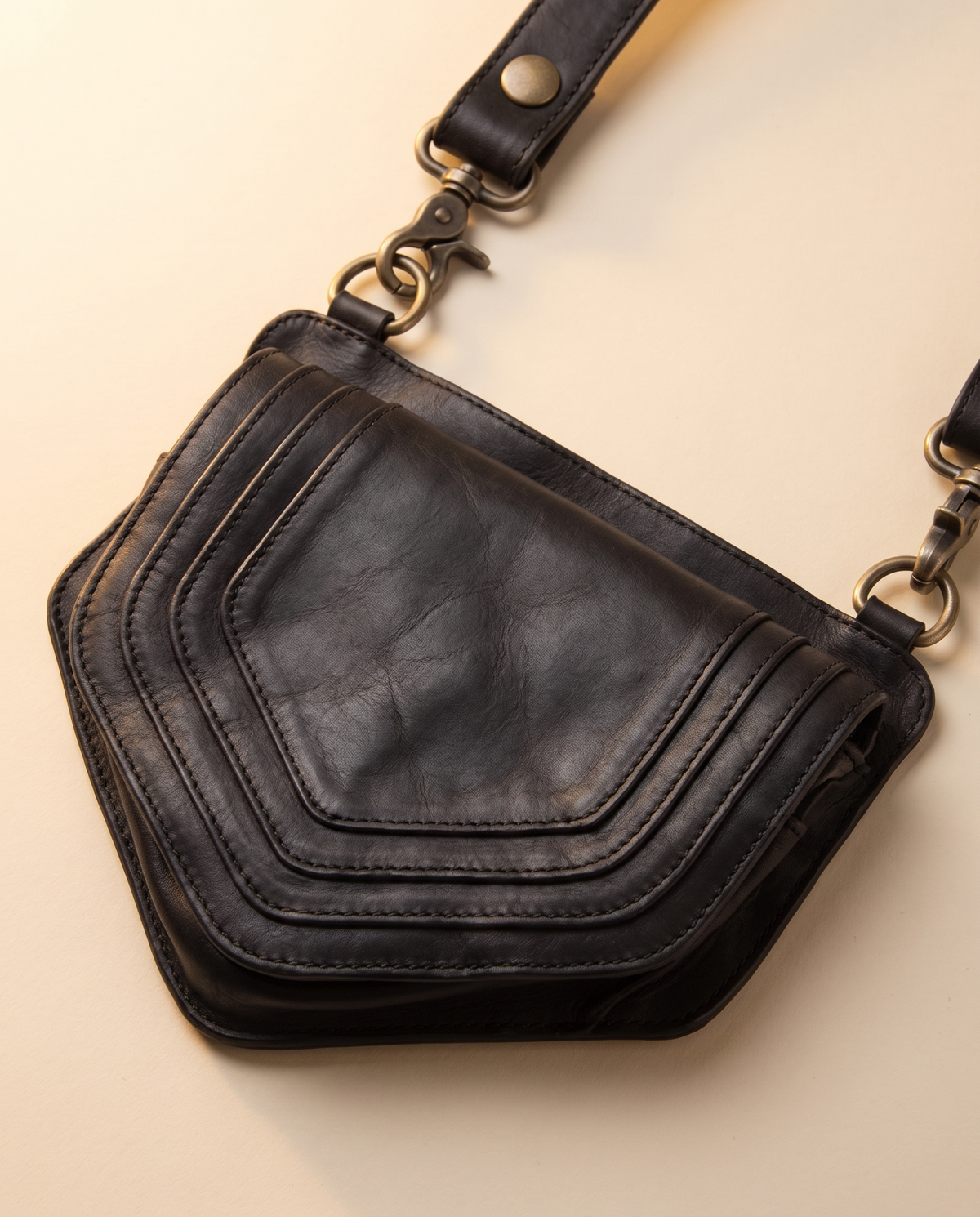 Black leather harness bag with two detachable pouches, by Ya Qalbi