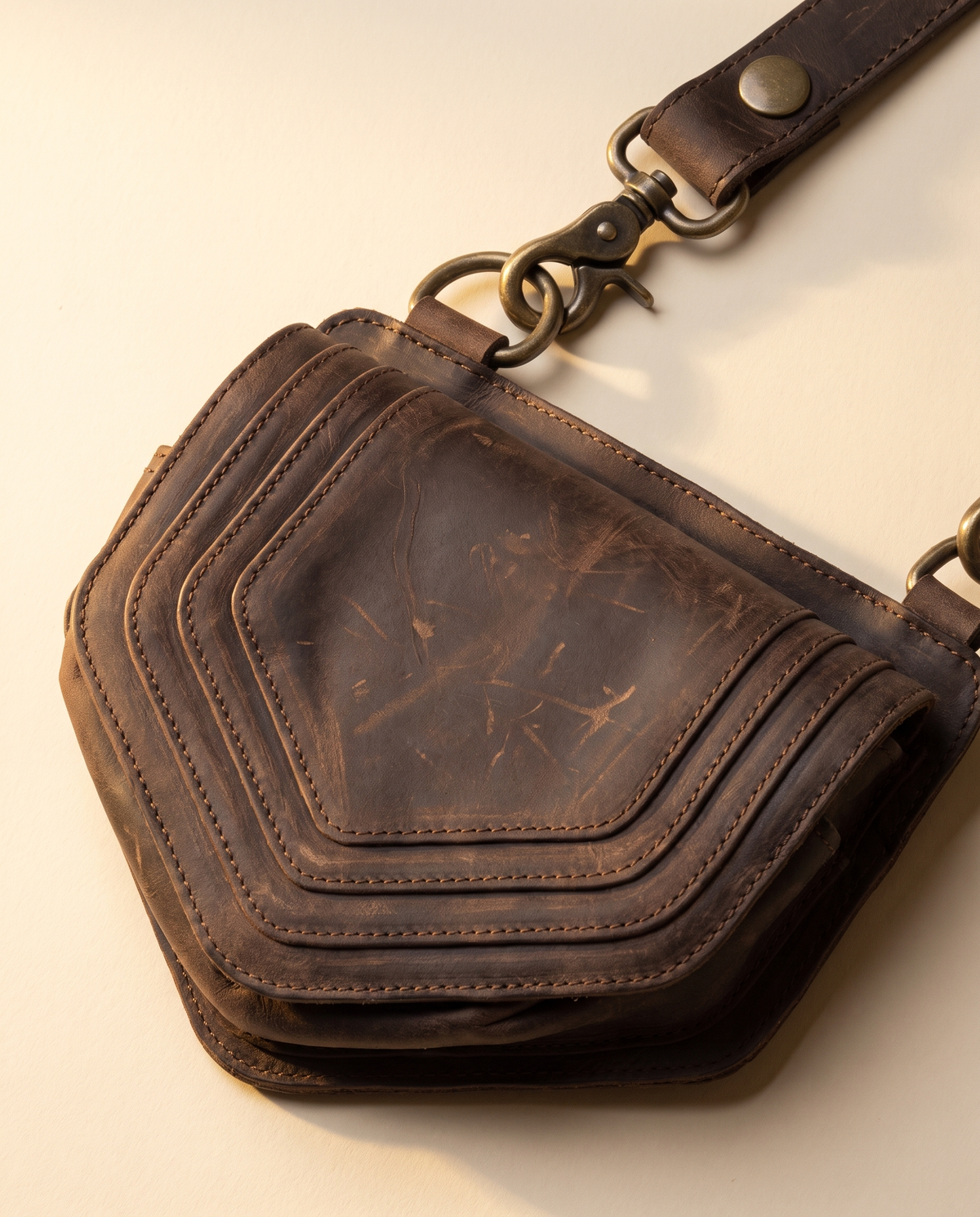 Dark brown leather harness bag with two detachable pouches, by Ya Qalbi