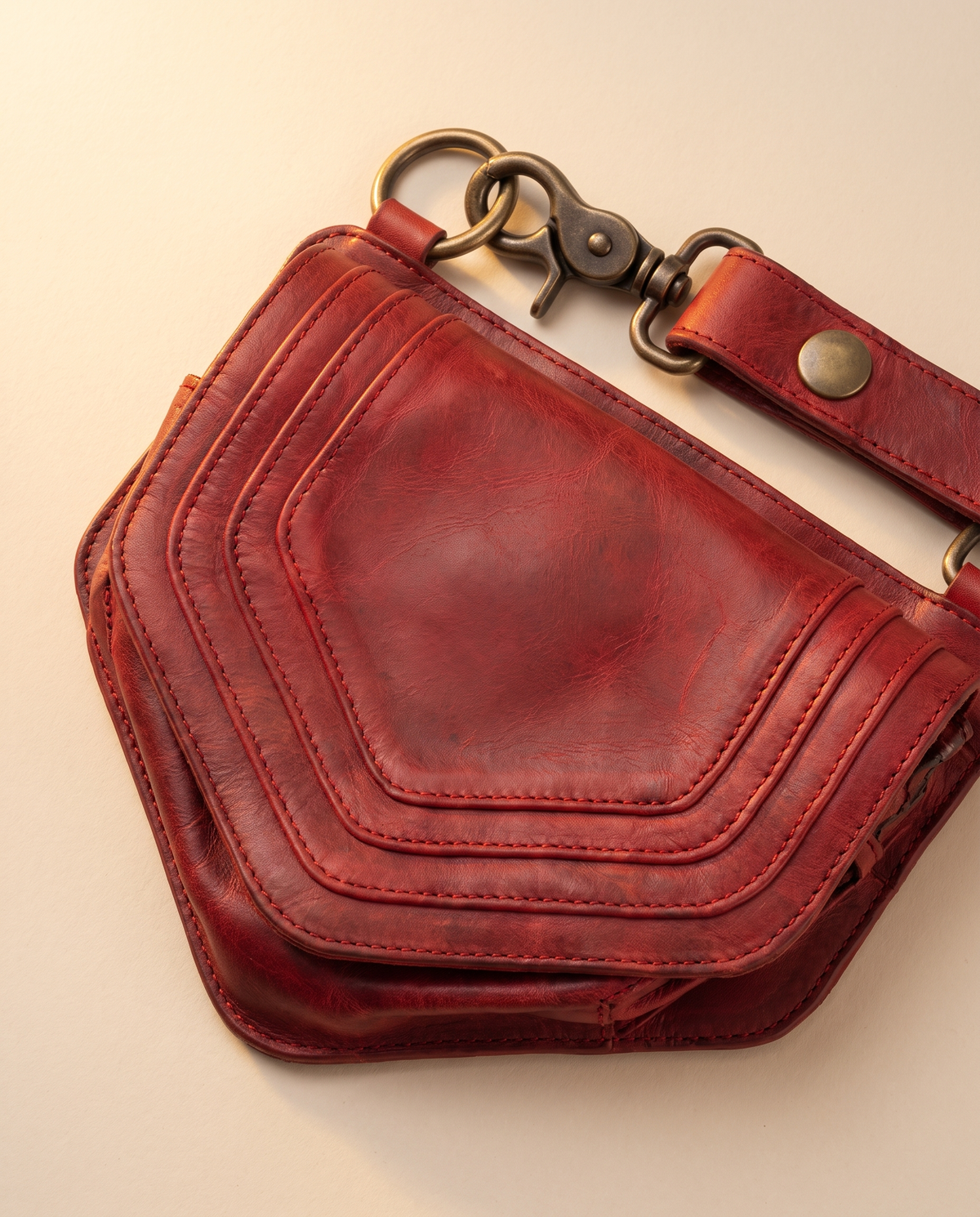 Red leather harness bag with two detachable pouches, by Ya Qalbi
