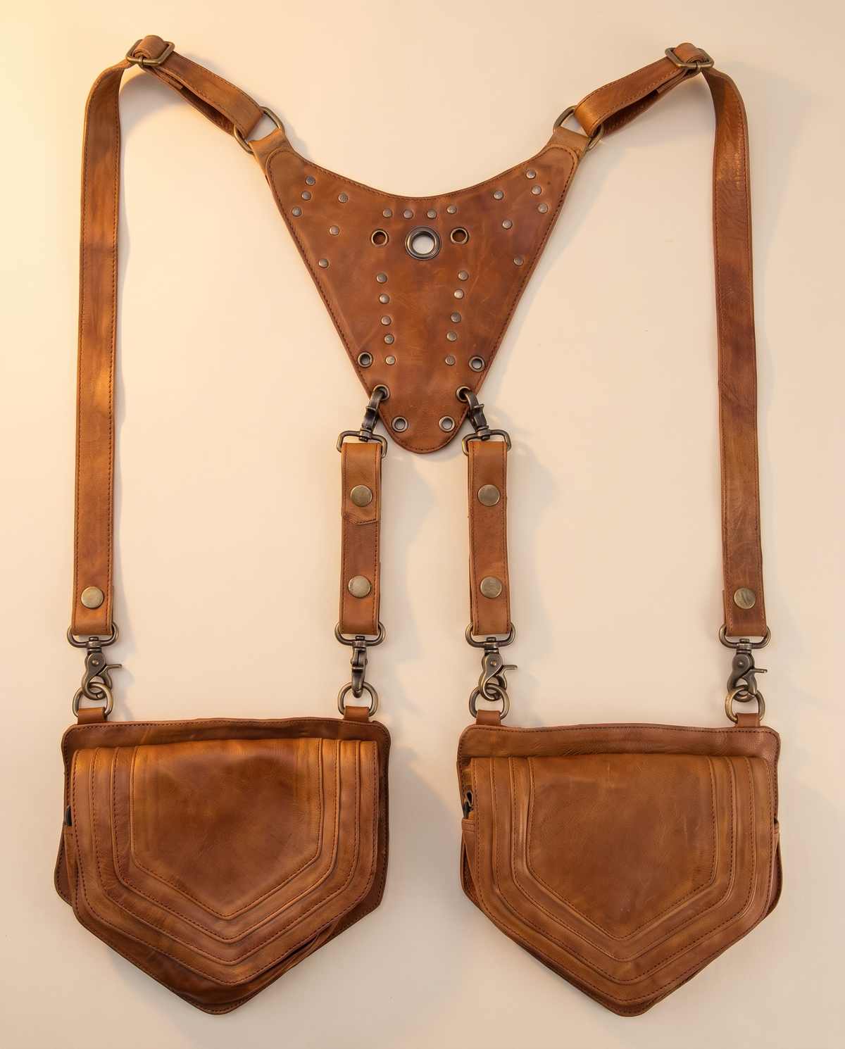 Tan leather harness bag with two detachable pouches, front view, by Ya Qalbi