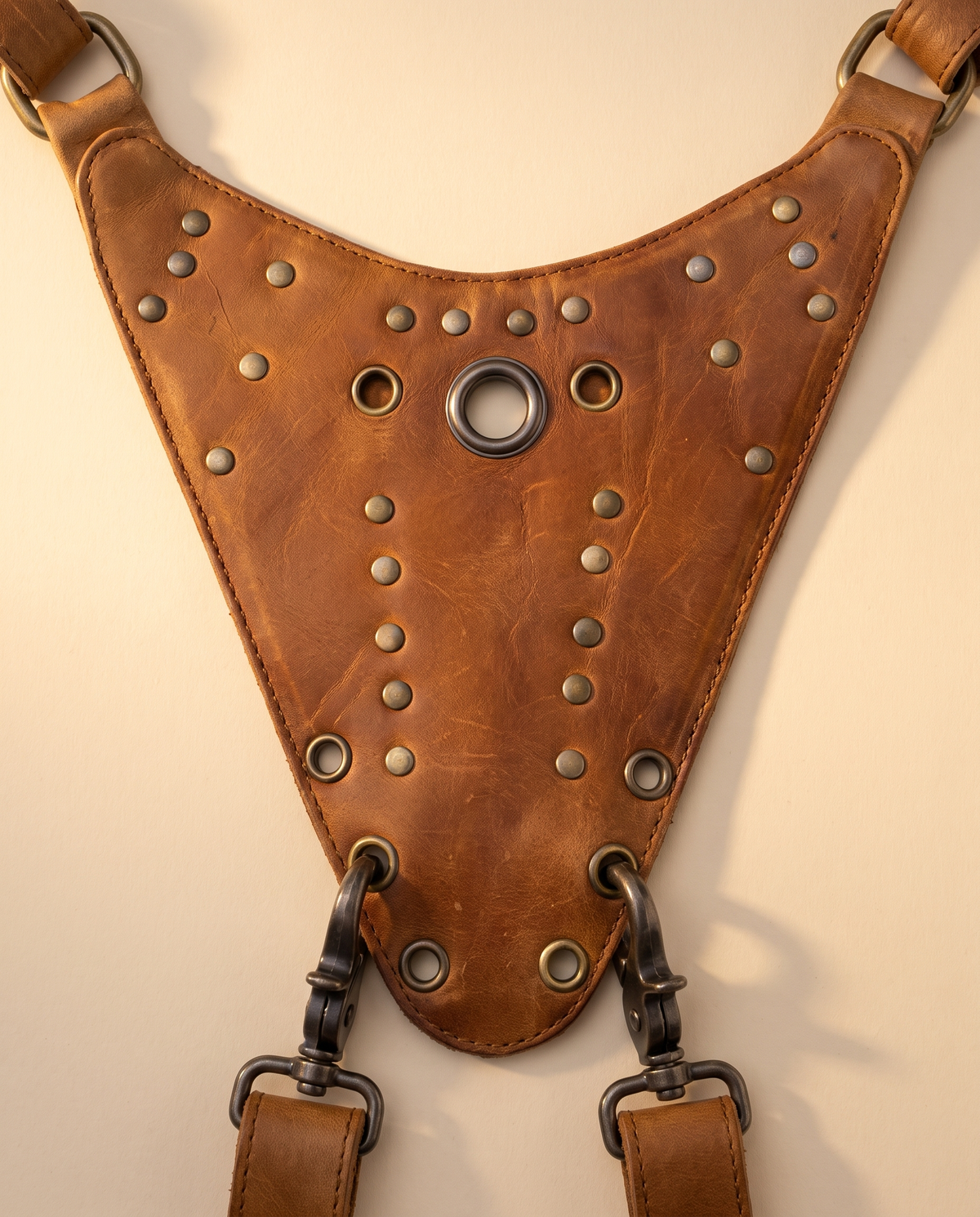 Tan leather harness bag with two detachable pouches, by Ya Qalbi