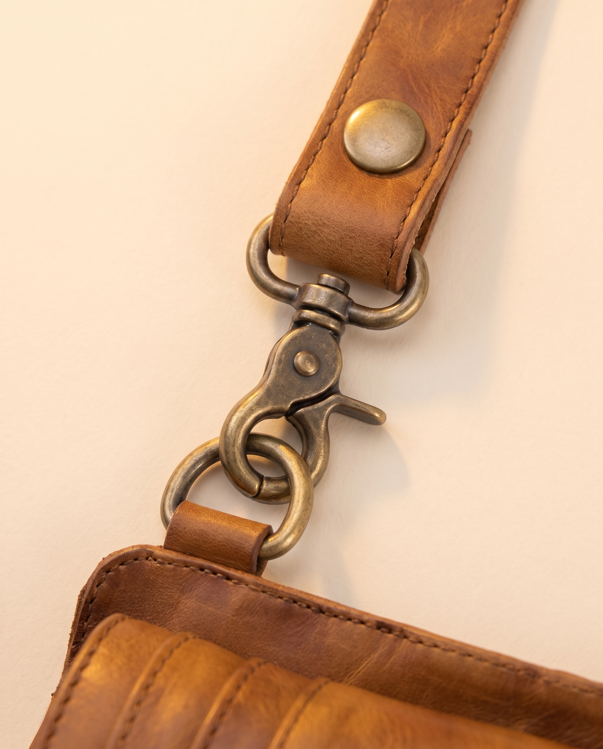 Tan leather harness bag with two detachable pouches, by Ya Qalbi