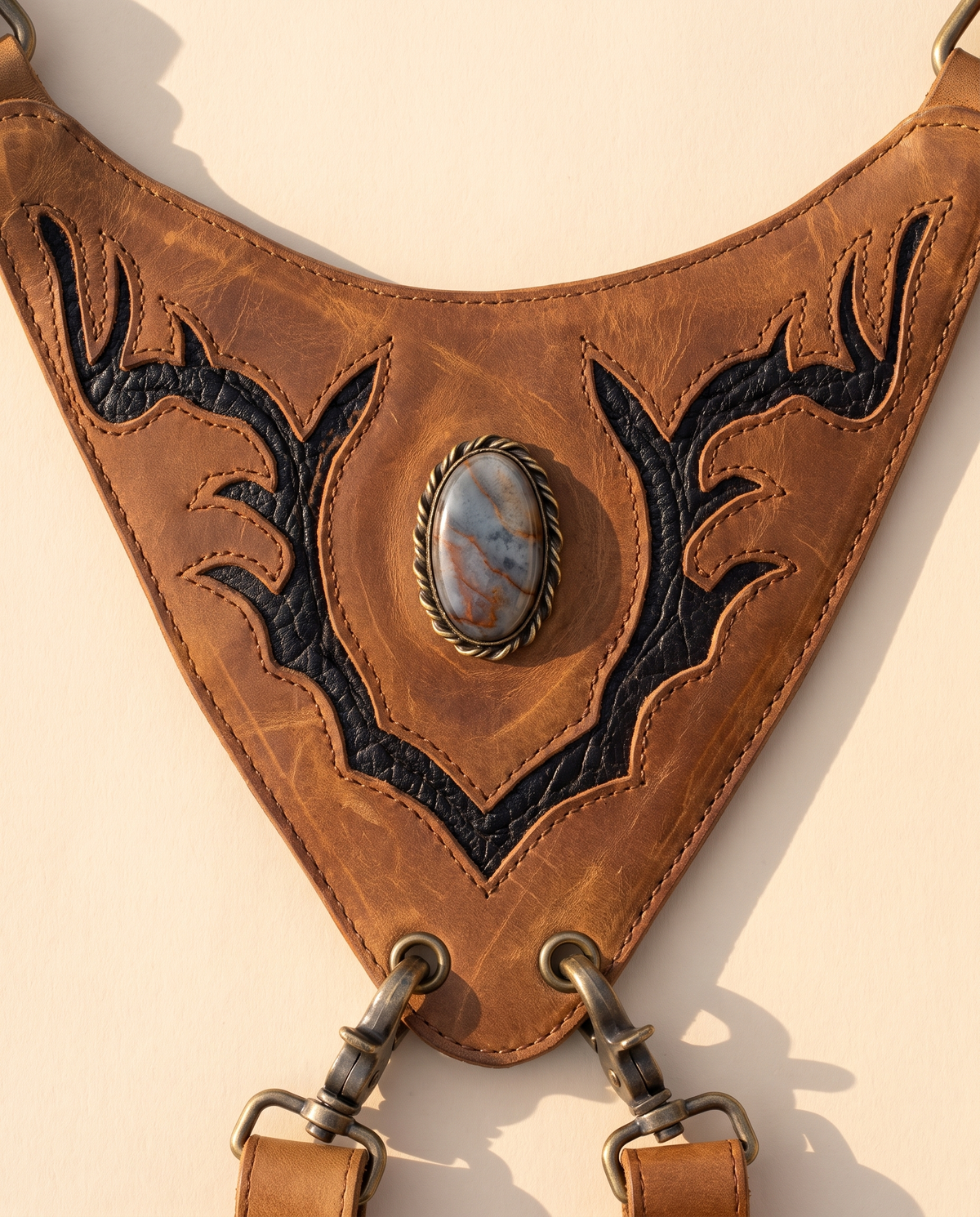 Tan and black hand-painted antler leather harness bag with gemstone, by Ya Qalbi