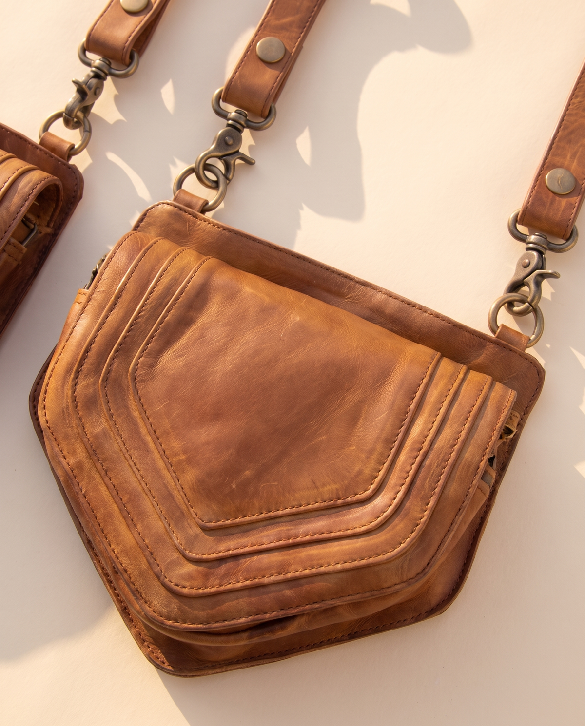 Tan and black hand-painted antler leather harness bag with gemstone, by Ya Qalbi