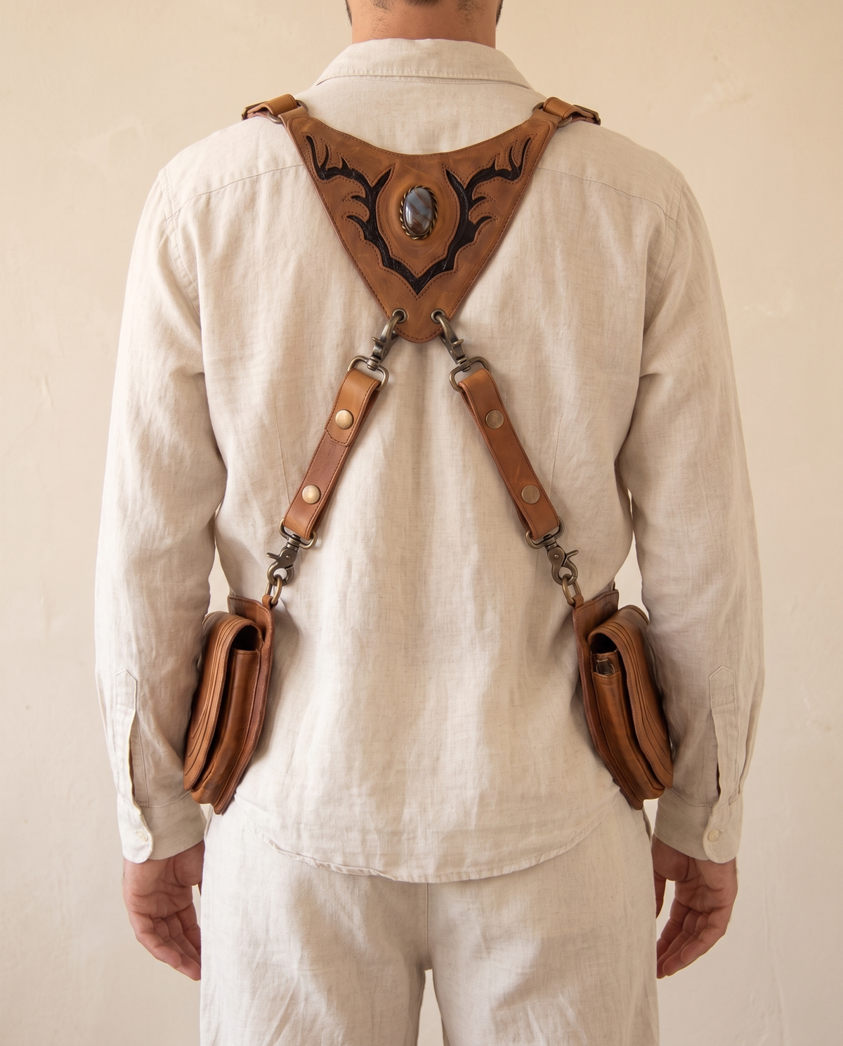 Tan and black hand-painted antler leather harness bag with gemstone, by Ya Qalbi