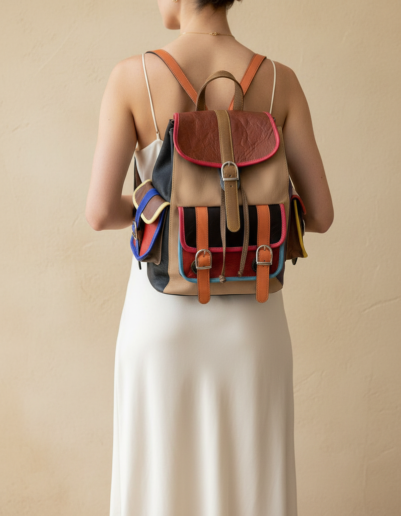 Hand-tooled flap close-up on striped leather backpack