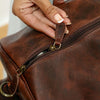 Hand-tooled leather duffle bag side view by Ya Qalbi