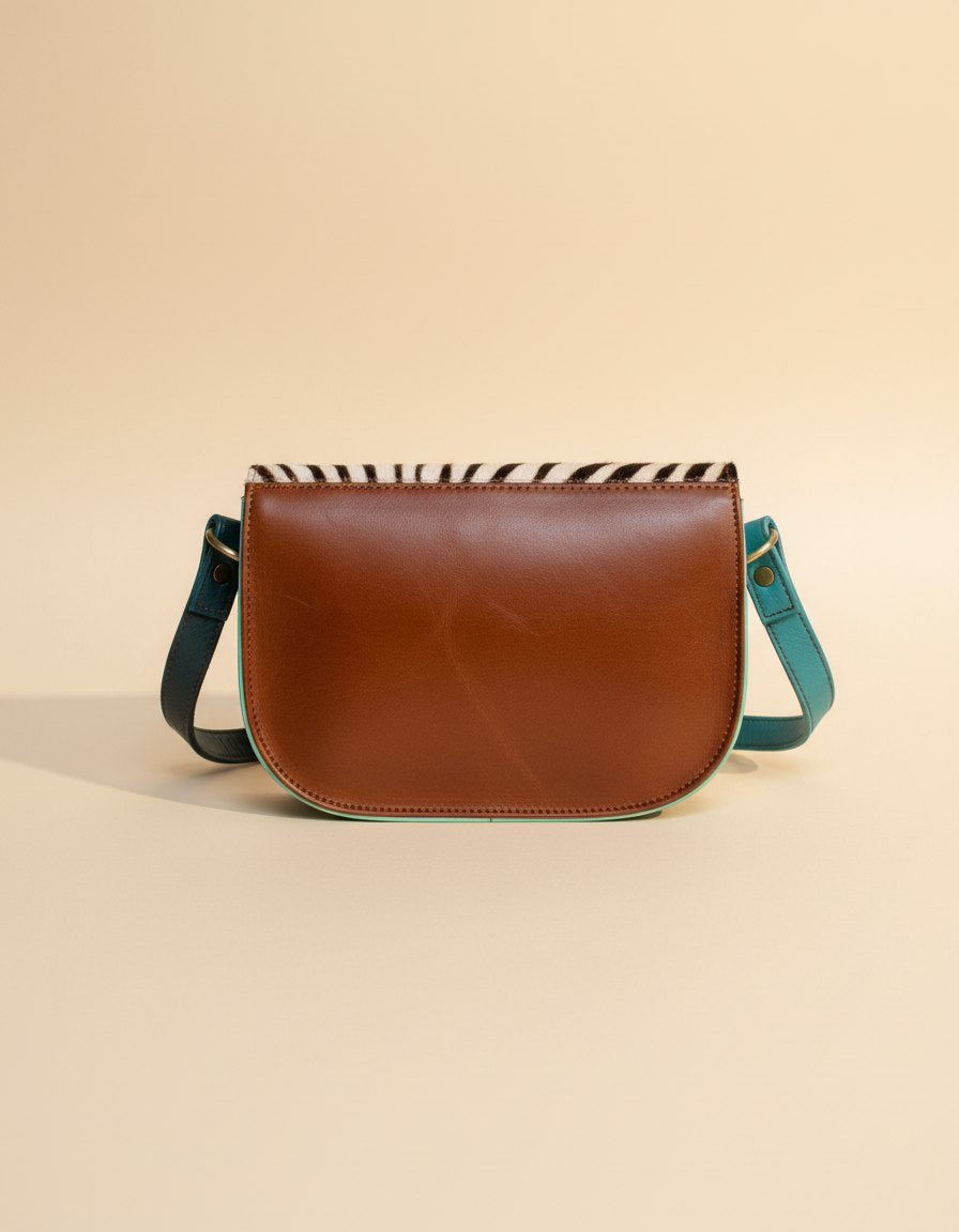 One-of-one hair-on flap saddle bag, zebra flap orange teal saddle colourway (cowhide)