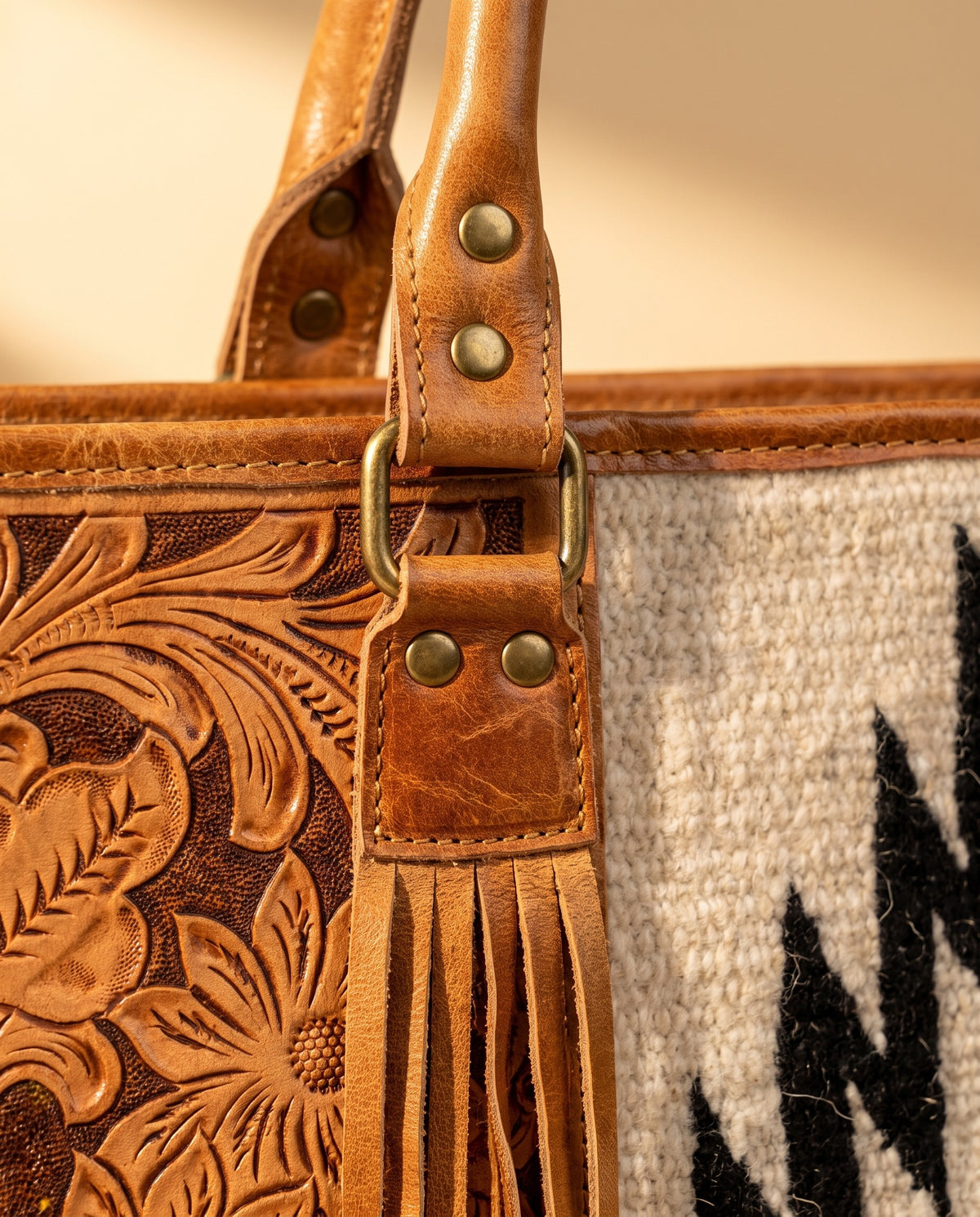 Black Aztec weave hand-tooled leather tote with fringe, handle ring and fringe close-up, by Ya Qalbi