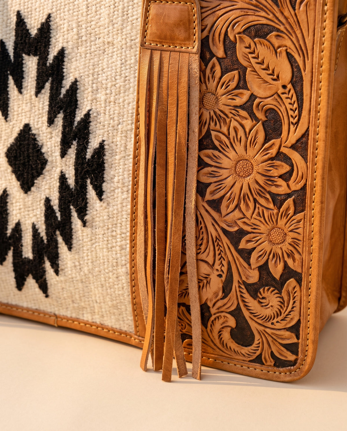 Black Aztec weave hand-tooled leather tote with fringe, woven Aztec panel and floral tooling close-up, by Ya Qalbi