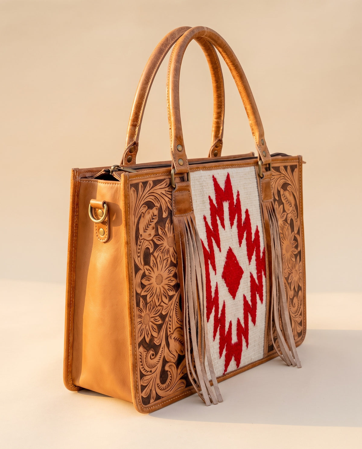 Red Aztec weave hand-tooled leather tote with fringe, angled view, by Ya Qalbi