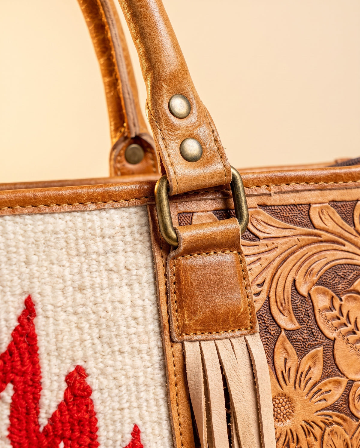 Red Aztec weave hand-tooled leather tote with fringe, handle ring and fringe close-up, by Ya Qalbi