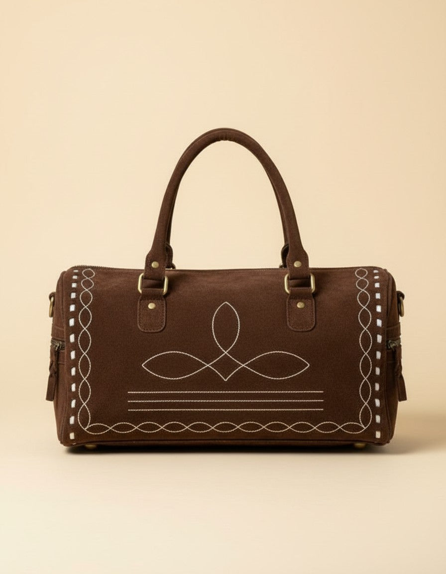 Brown suede bootstitch barrel bag with white buckstitch edges, front view, by Ya Qalbi