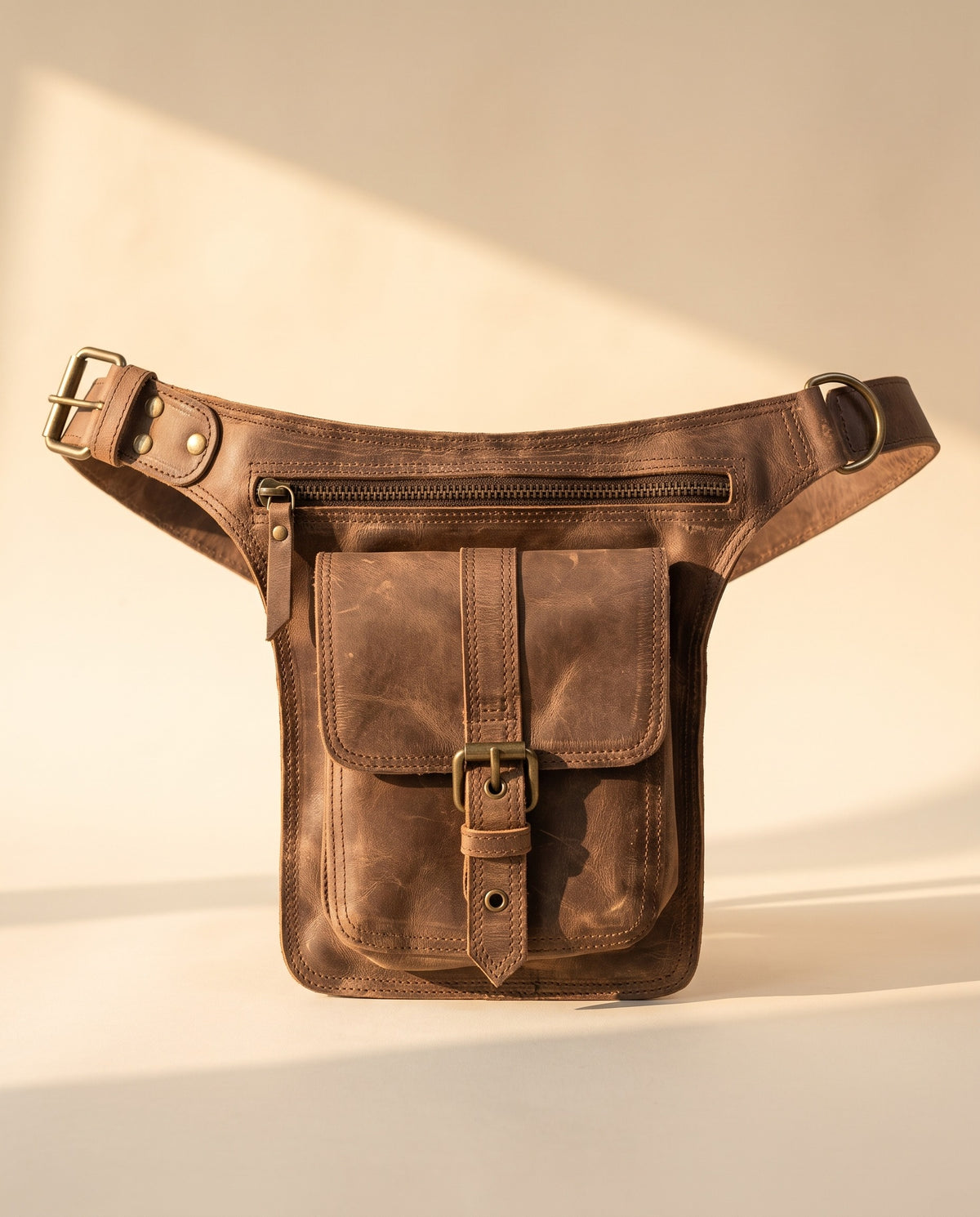 Brown leather leg bag with buckle pocket, front view, by Ya Qalbi