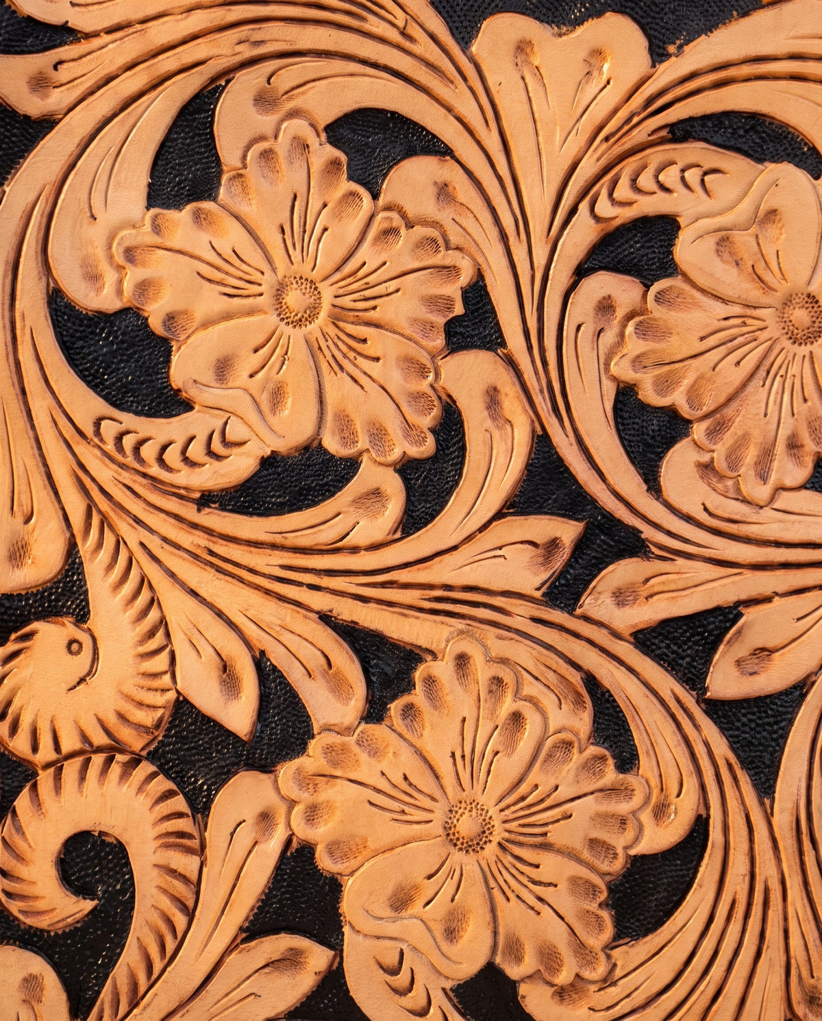Black hand-tooled leather bag with cut-out handle, detail close-up, by Ya Qalbi