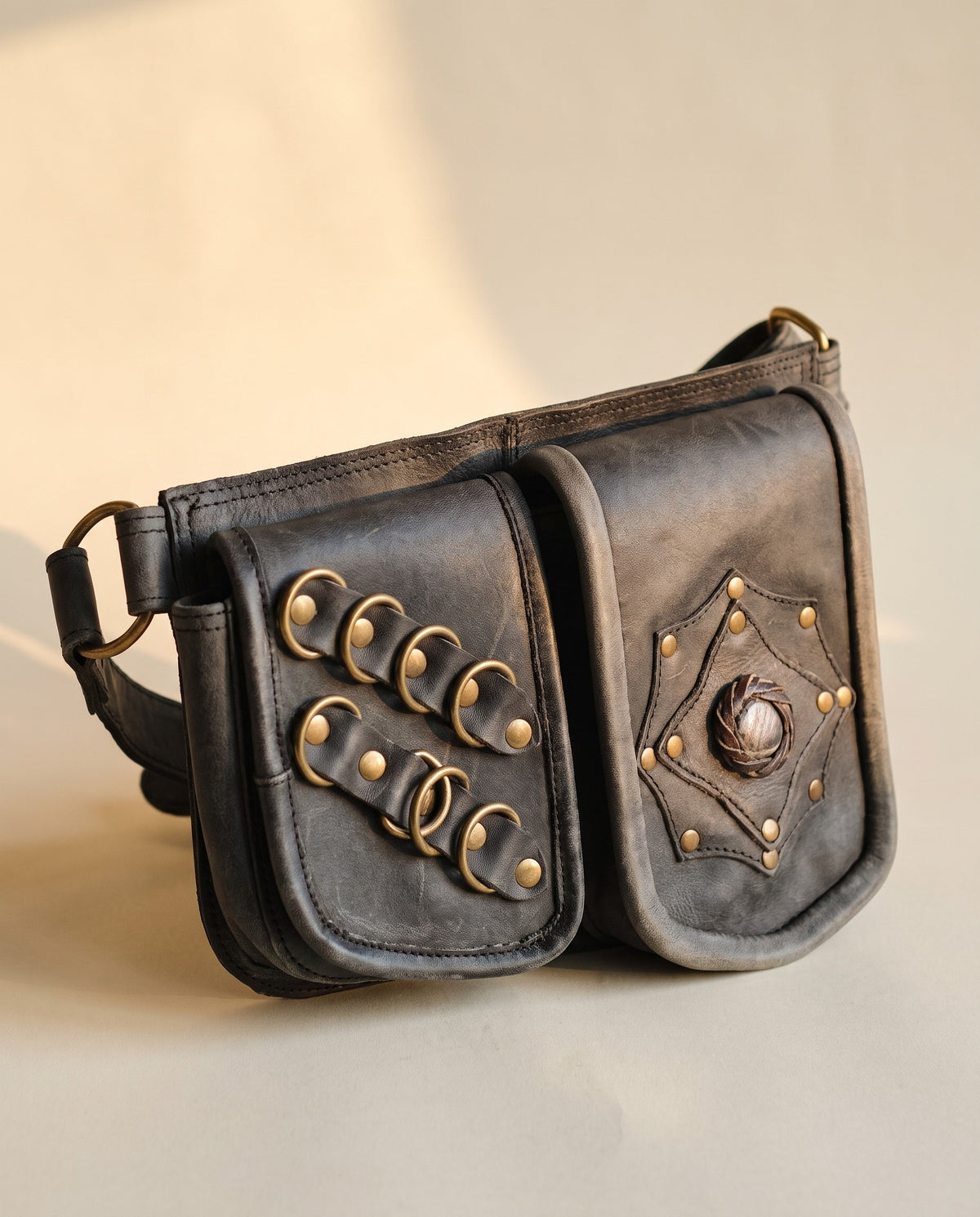 Black double pouch leather hip belt with rings and stone, angled view, by Ya Qalbi