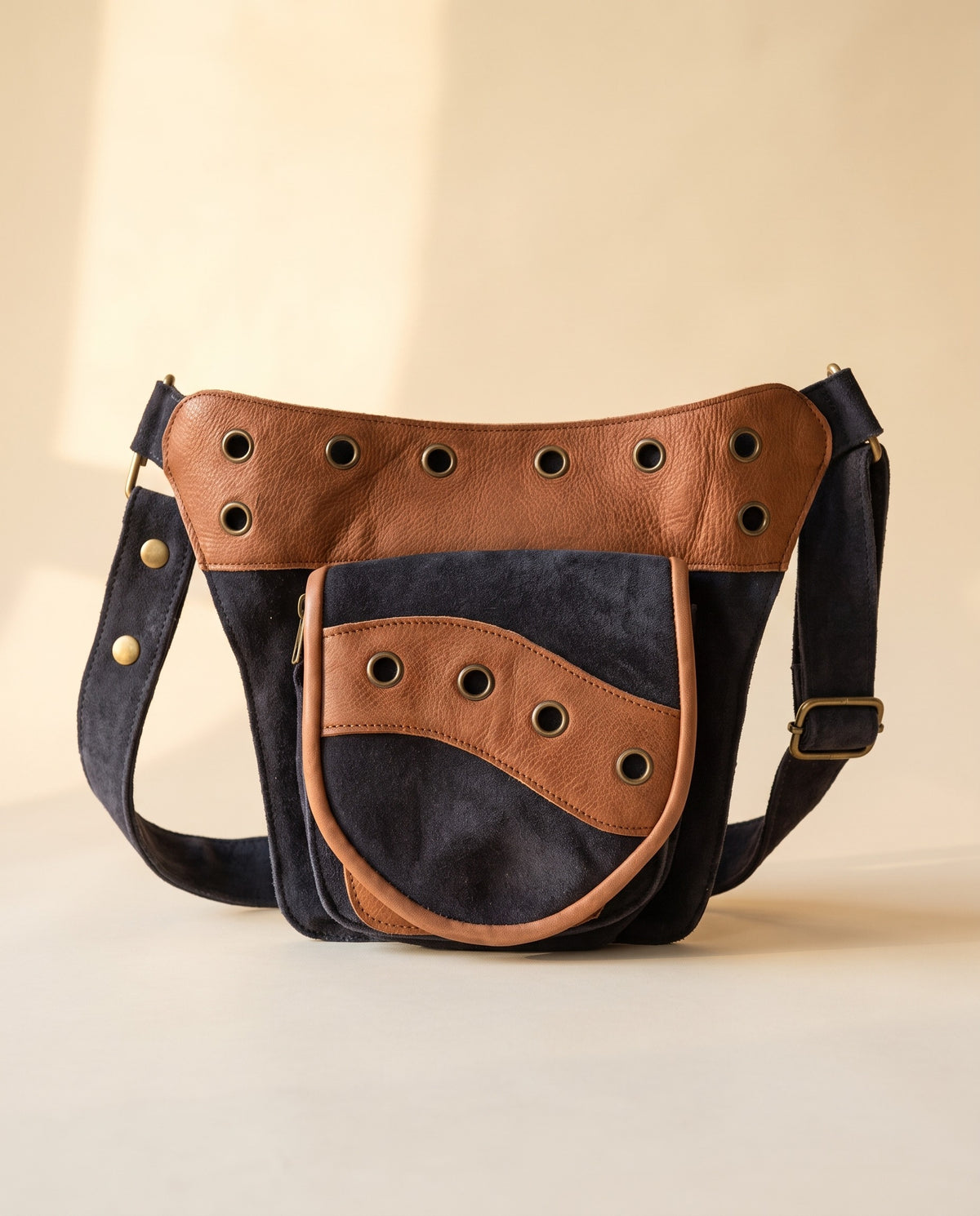 Navy and tan eyelet suede hip bag, front view, by Ya Qalbi