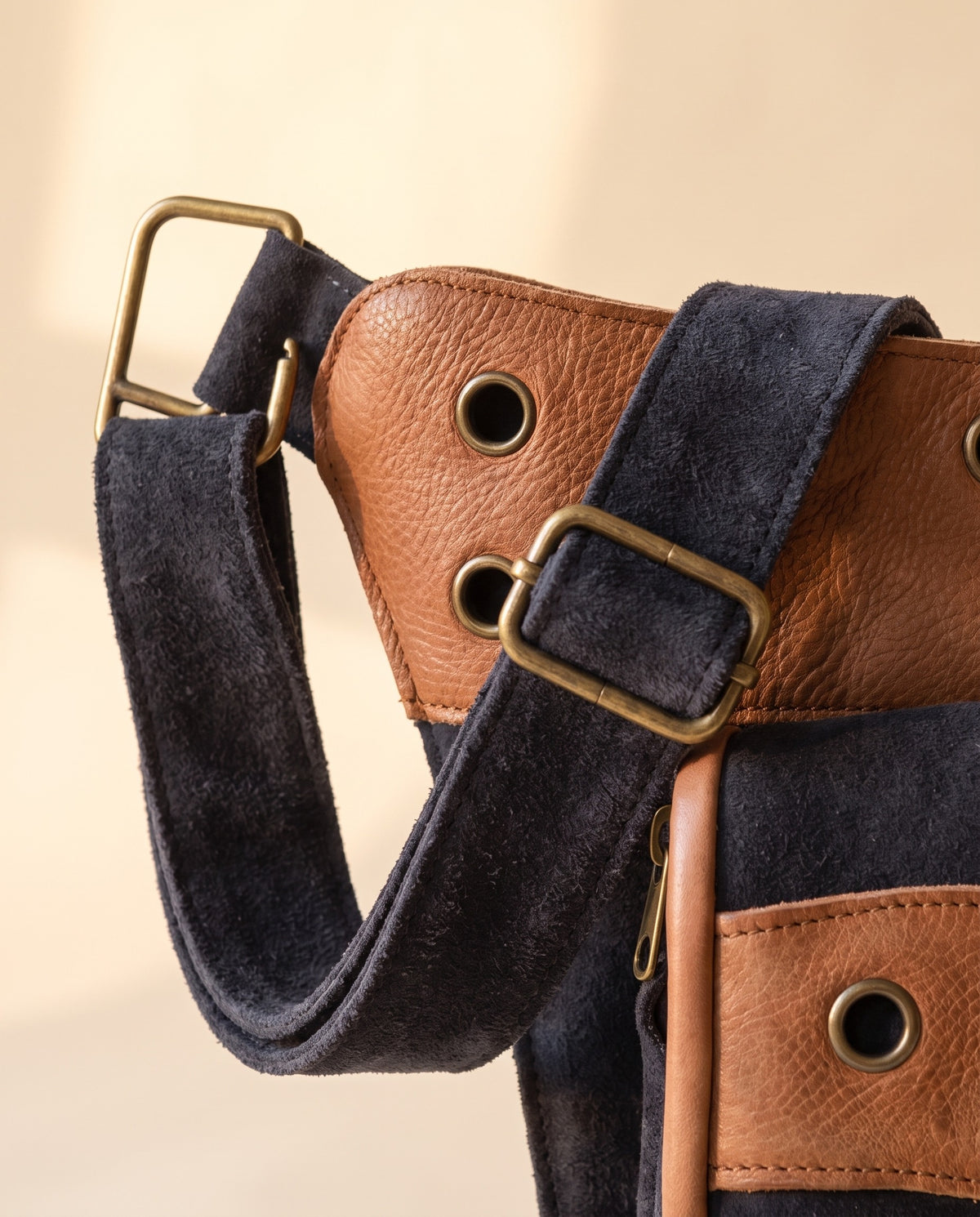 Navy and tan eyelet suede hip bag, detail close-up, by Ya Qalbi