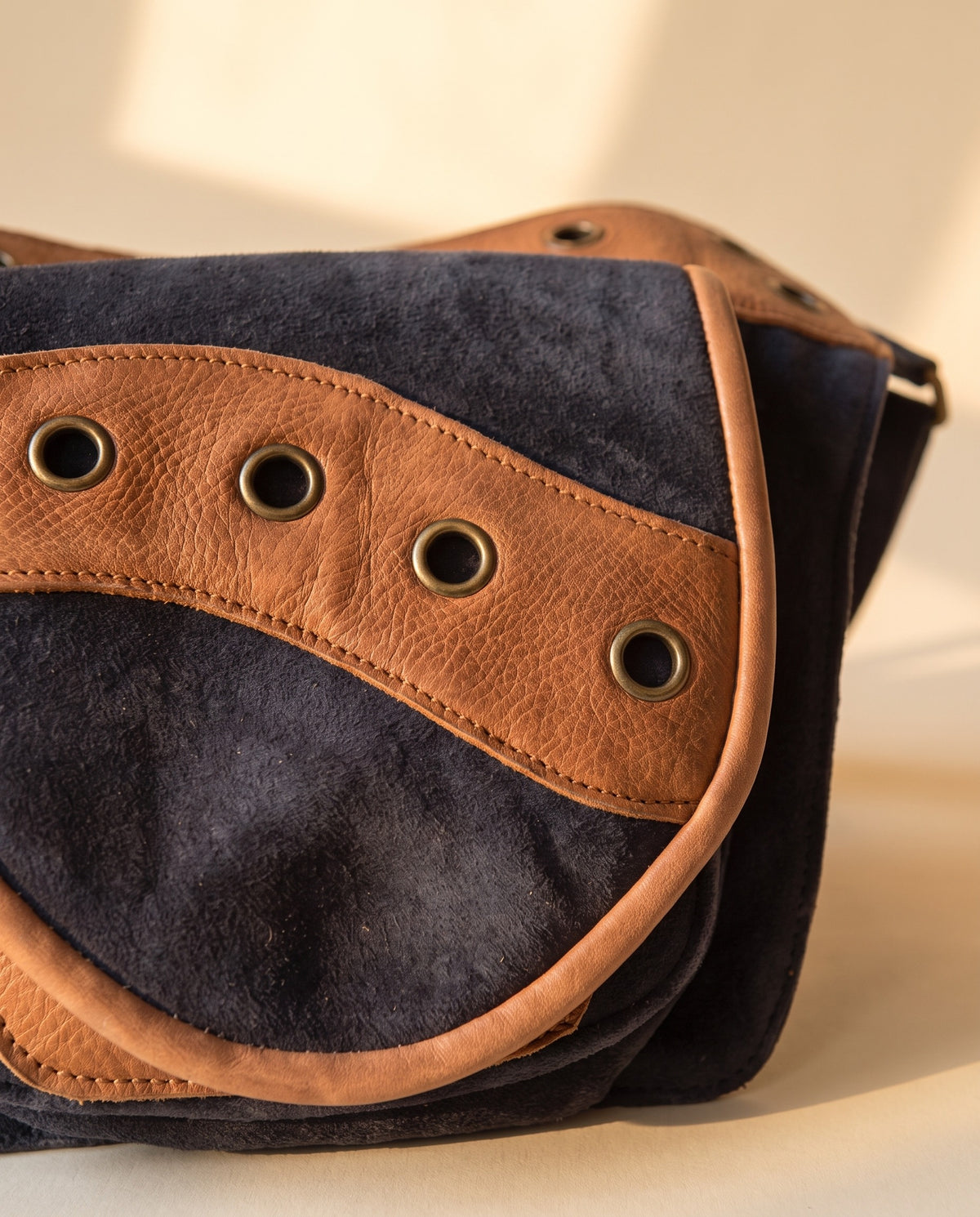 Navy and tan eyelet suede hip bag, detail close-up, by Ya Qalbi
