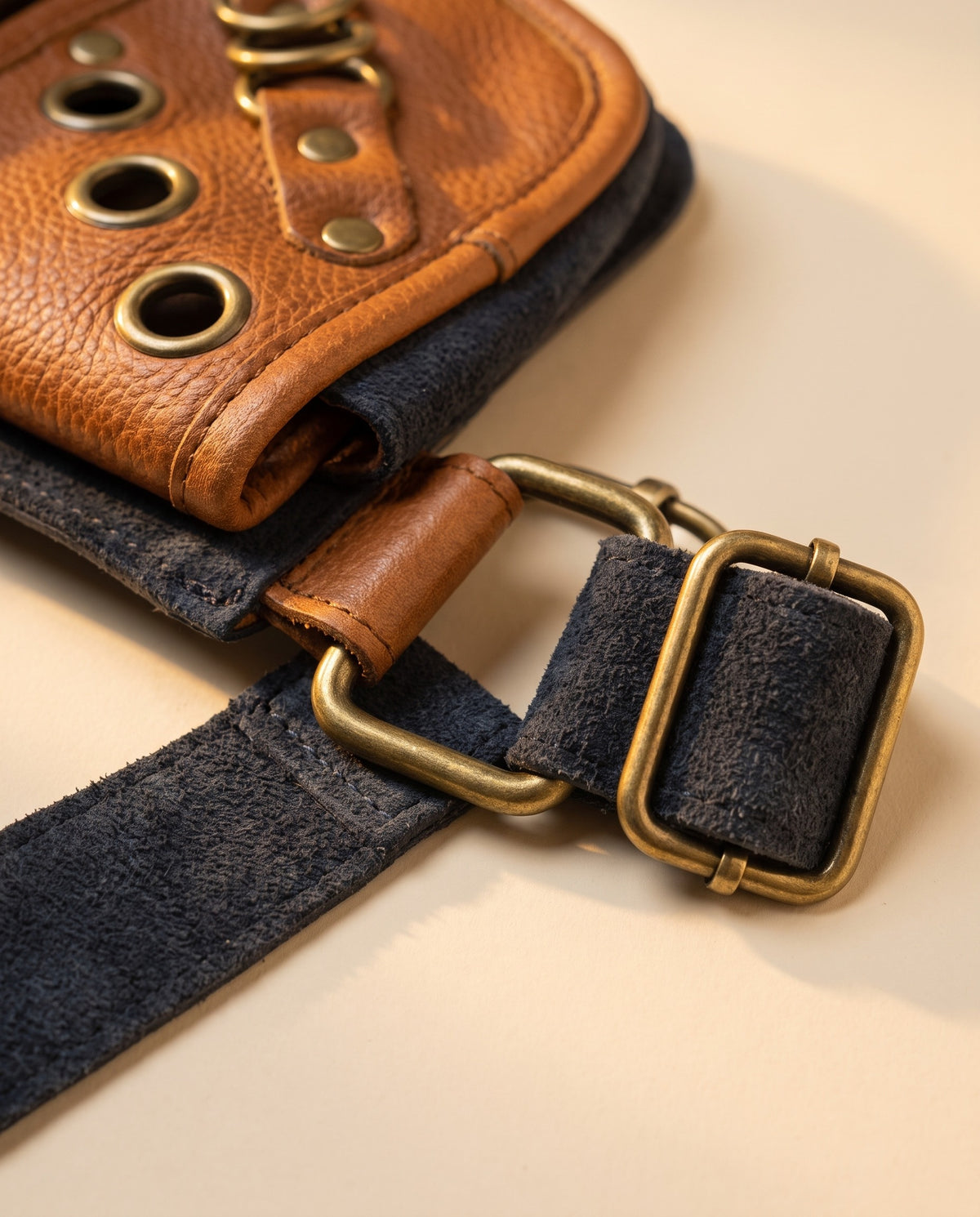 Navy and tan eyelet suede hip bag, detail close-up, by Ya Qalbi