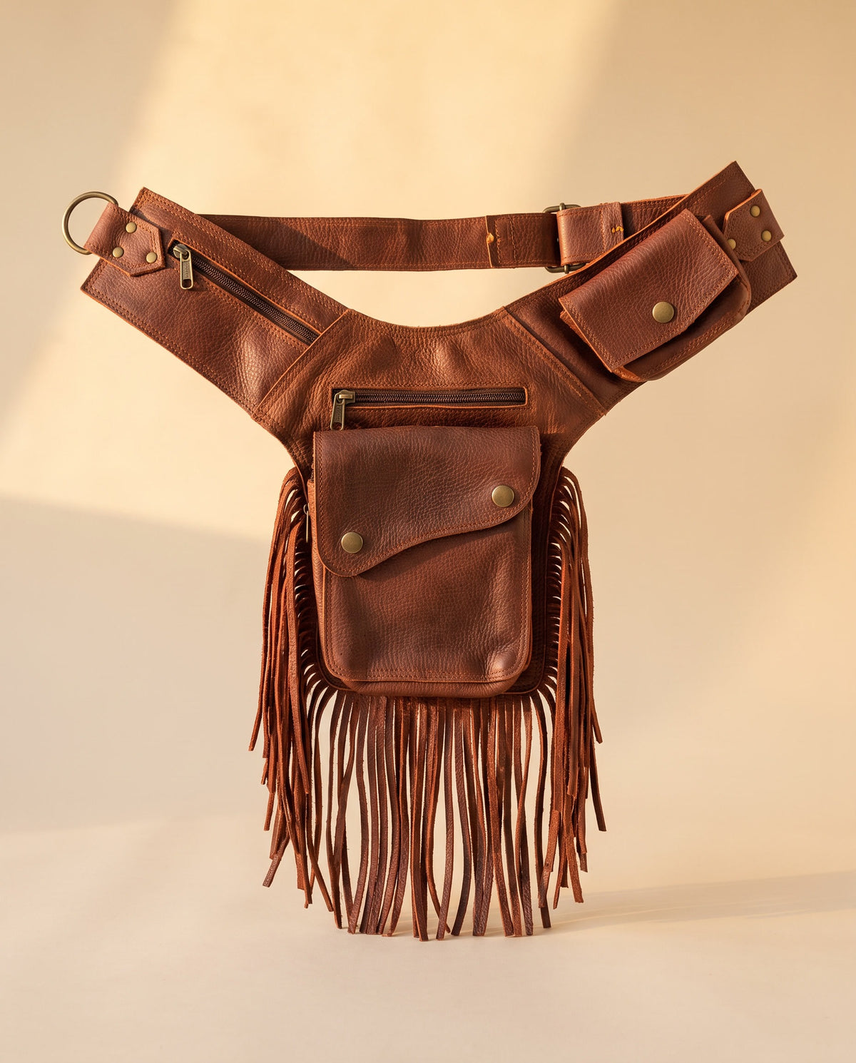 Brown fringe leather holster hip bag, front view, by Ya Qalbi