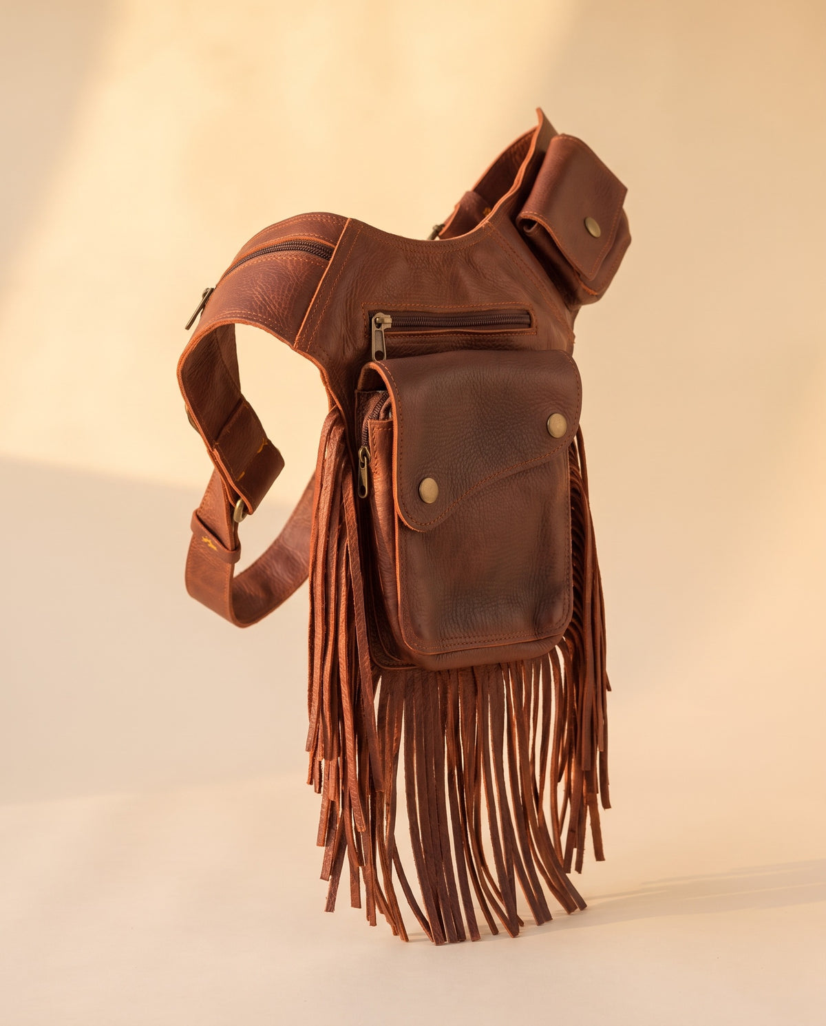 Brown fringe leather holster hip bag, angled view, by Ya Qalbi
