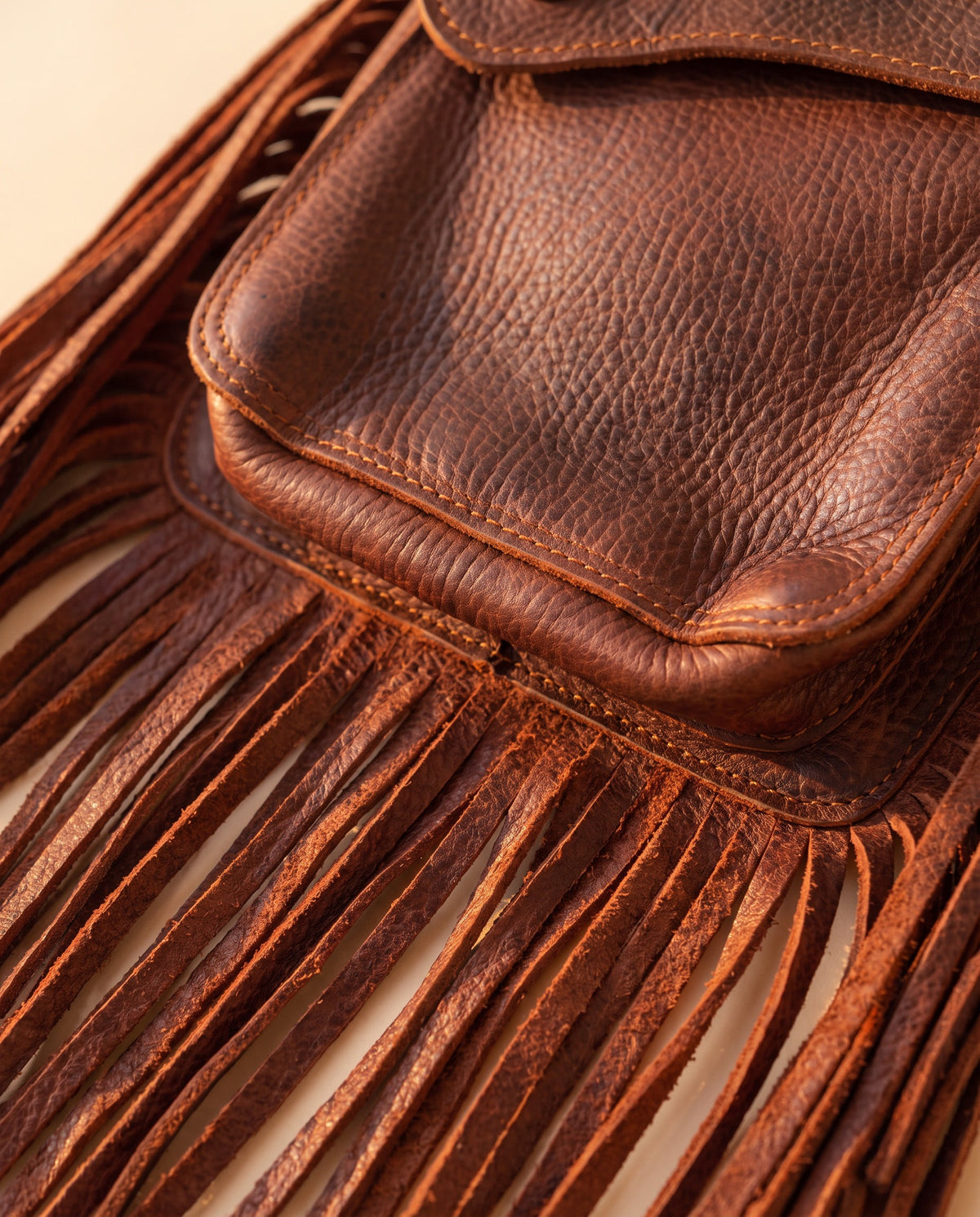 Brown fringe leather holster hip bag, detail close-up, by Ya Qalbi