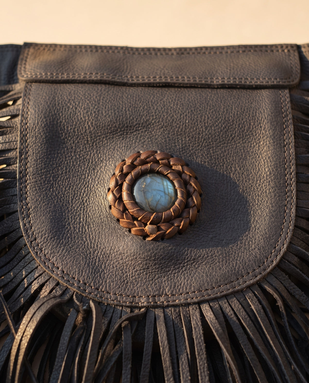 Black fringe leather hip bag with stone, detail close-up, by Ya Qalbi