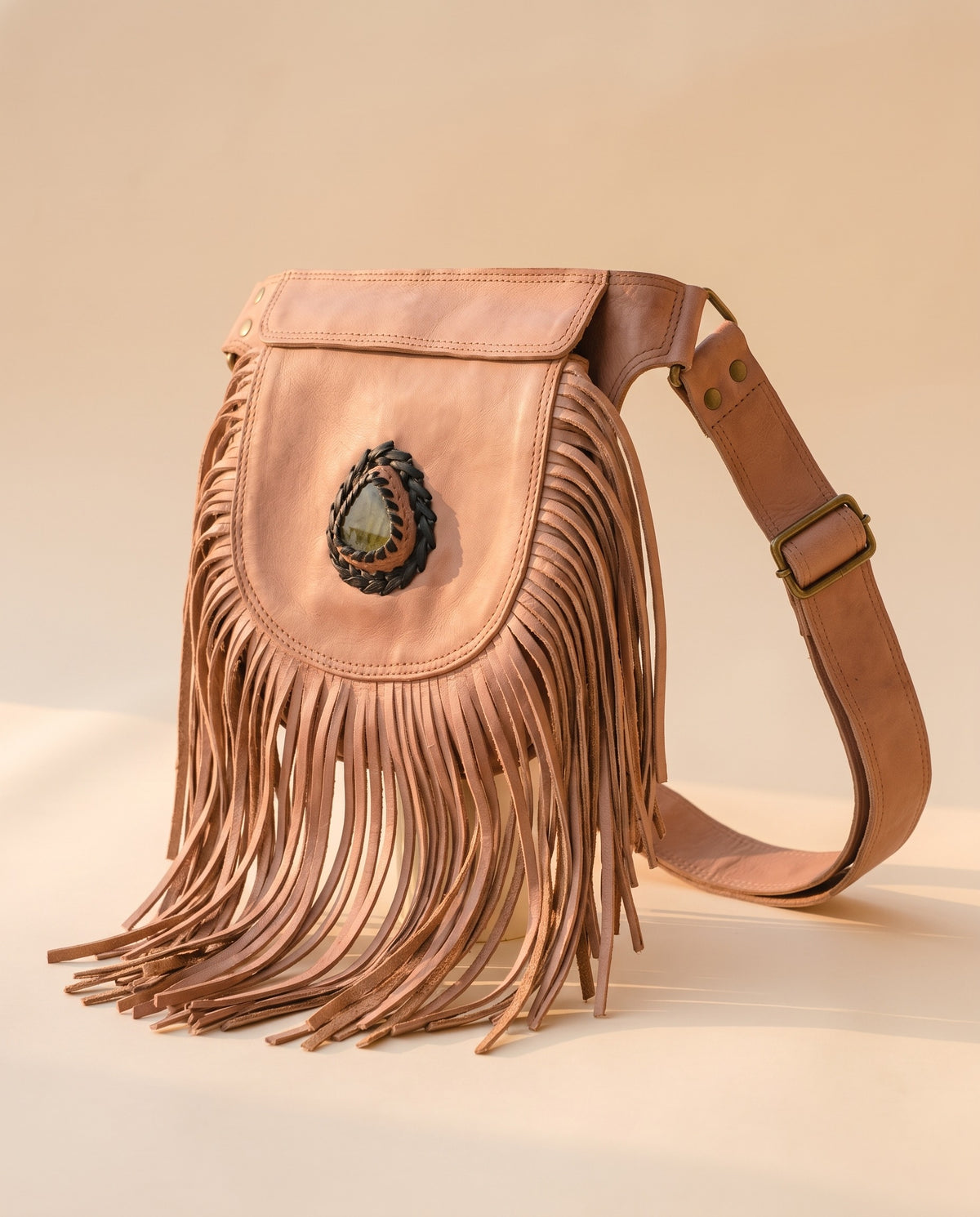 Blush fringe leather hip bag with stone, angled view, by Ya Qalbi