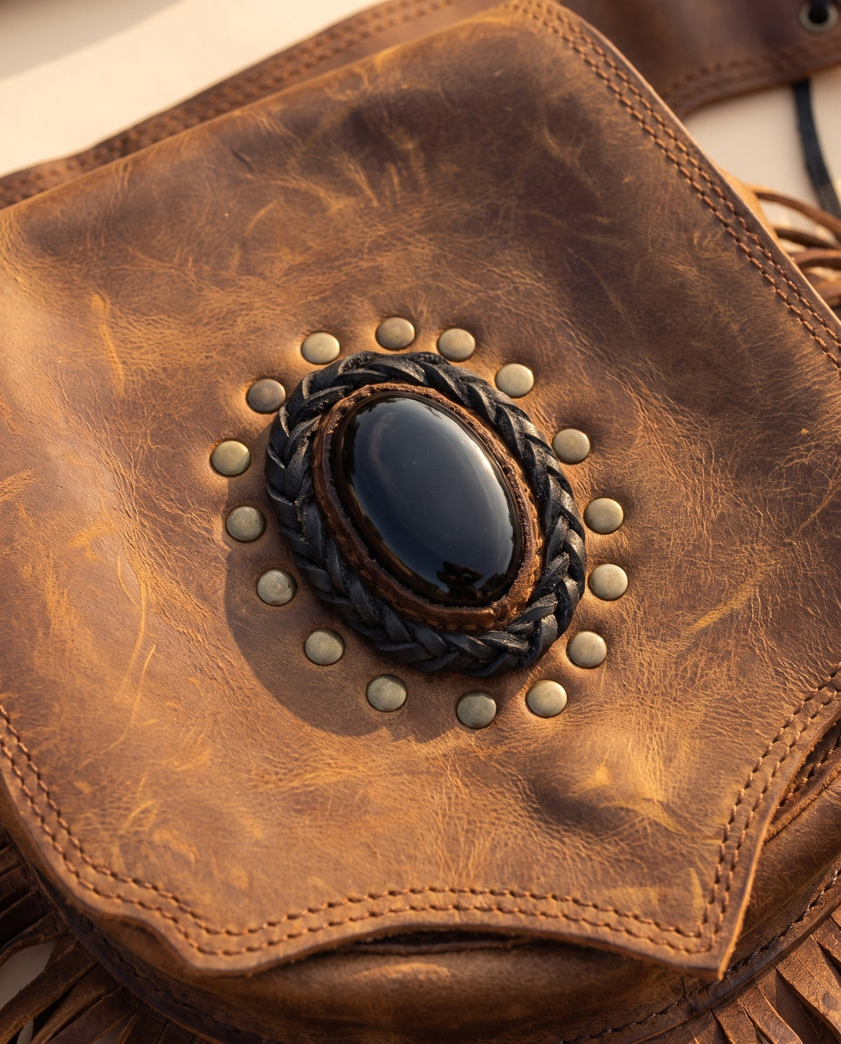 Brown fringe leather hip bag with stone, detail close-up, by Ya Qalbi
