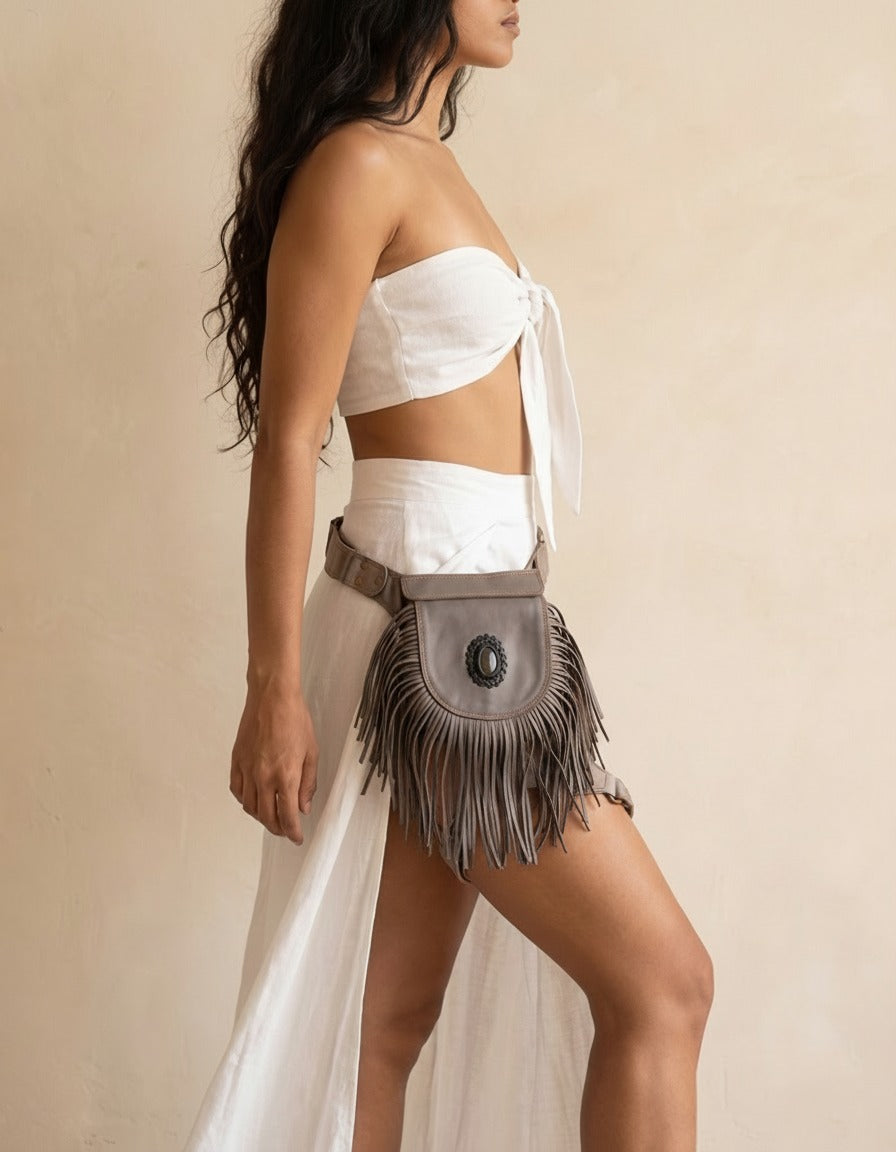 Grey fringe leather hip bag with stone, worn by a model, by Ya Qalbi