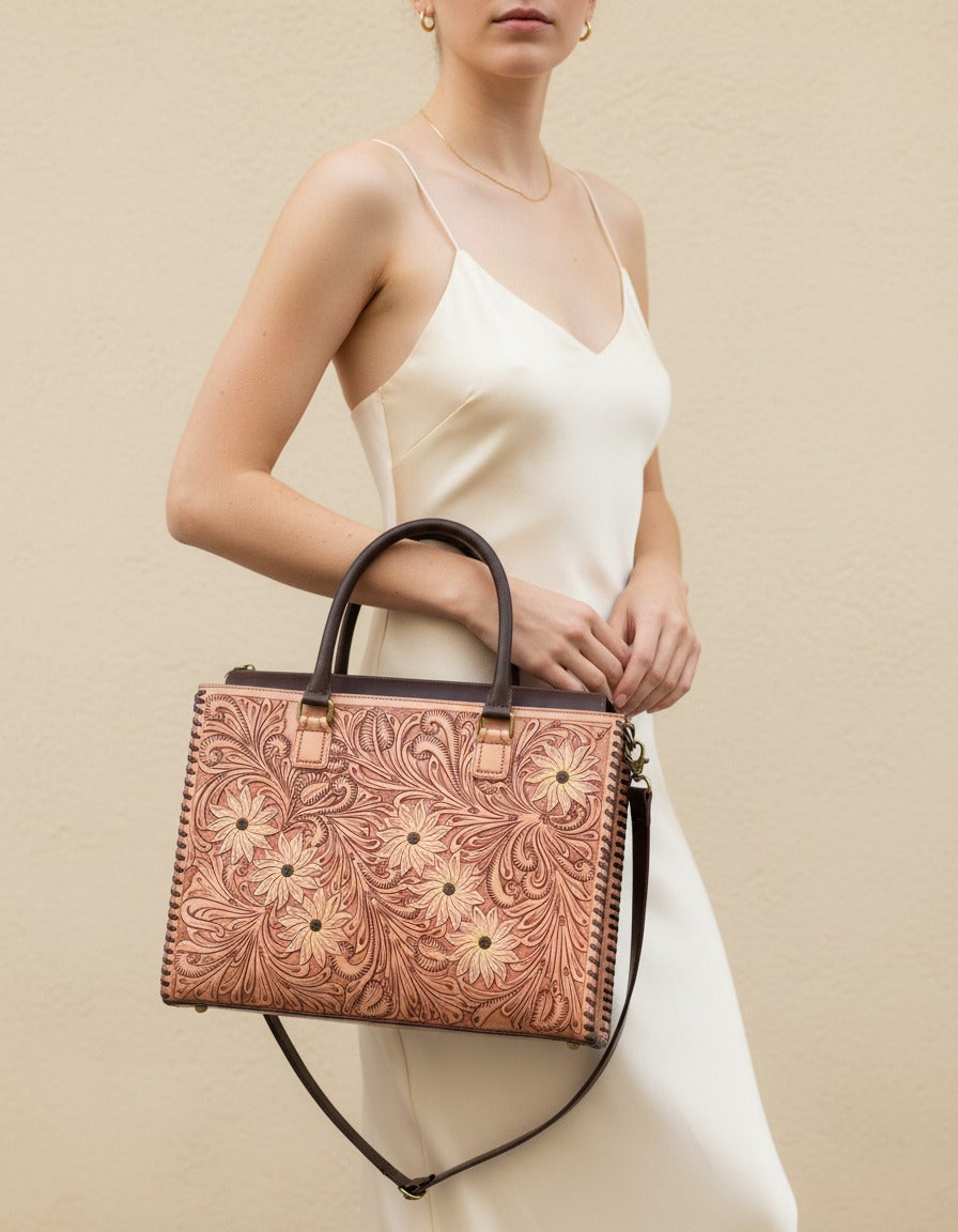 Sunflower painted hand-tooled leather tote, worn by a model, by Ya Qalbi