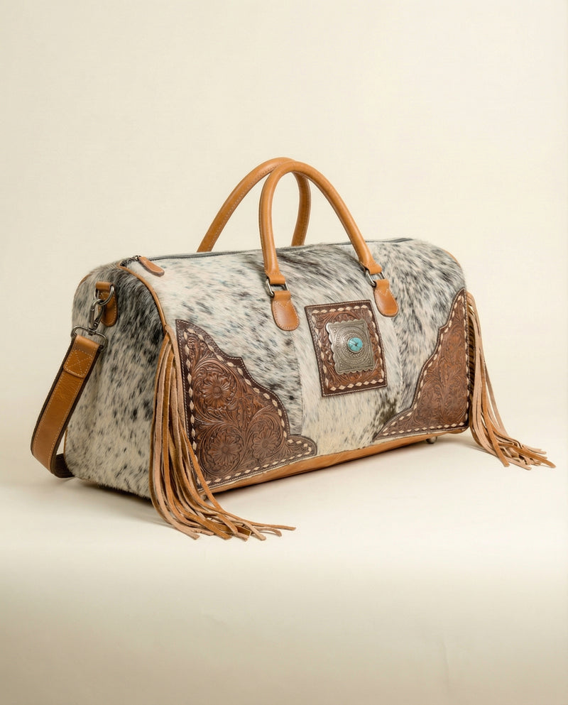 Statement hair-on leather duffle with fringe corners by Ya Qalbi