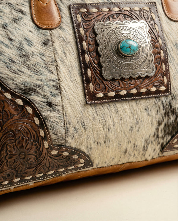 Cowhide leather weekender with hand-tooled border by Ya Qalbi