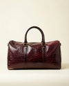 Rich maroon croc-textured leather weekender by Ya Qalbi