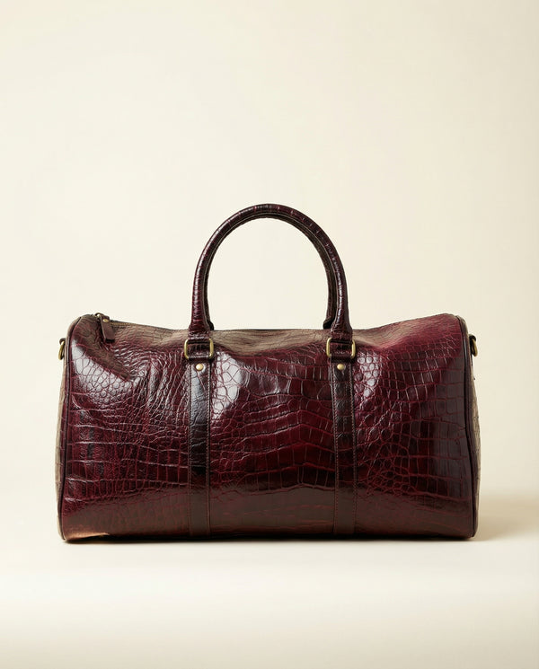Rich maroon croc-textured leather weekender by Ya Qalbi