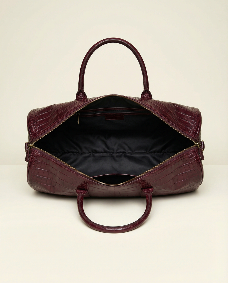 Maroon crocodile leather weekender bag with brass studs by Ya Qalbi