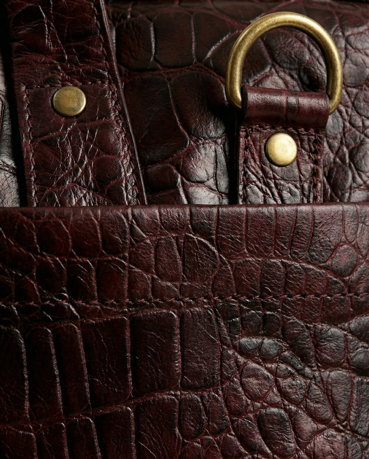 Close-up of D-ring on oxblood croc leather