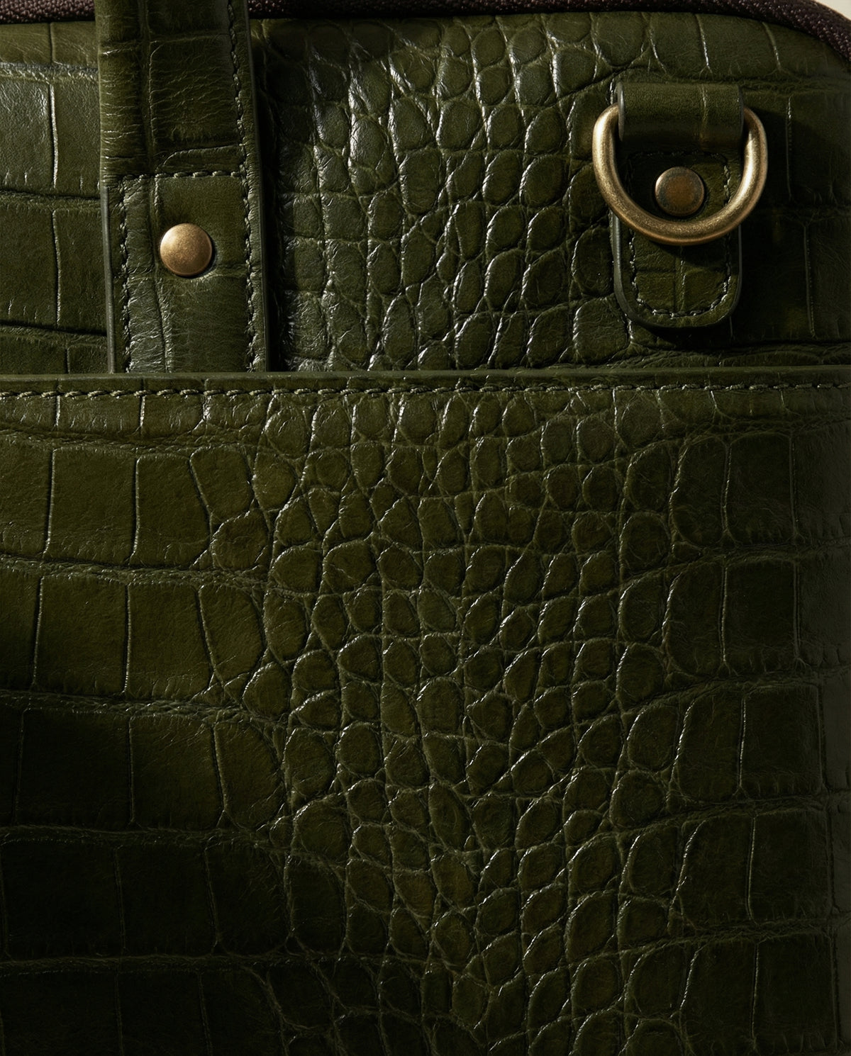 Close-up of D-ring on olive green croc leather