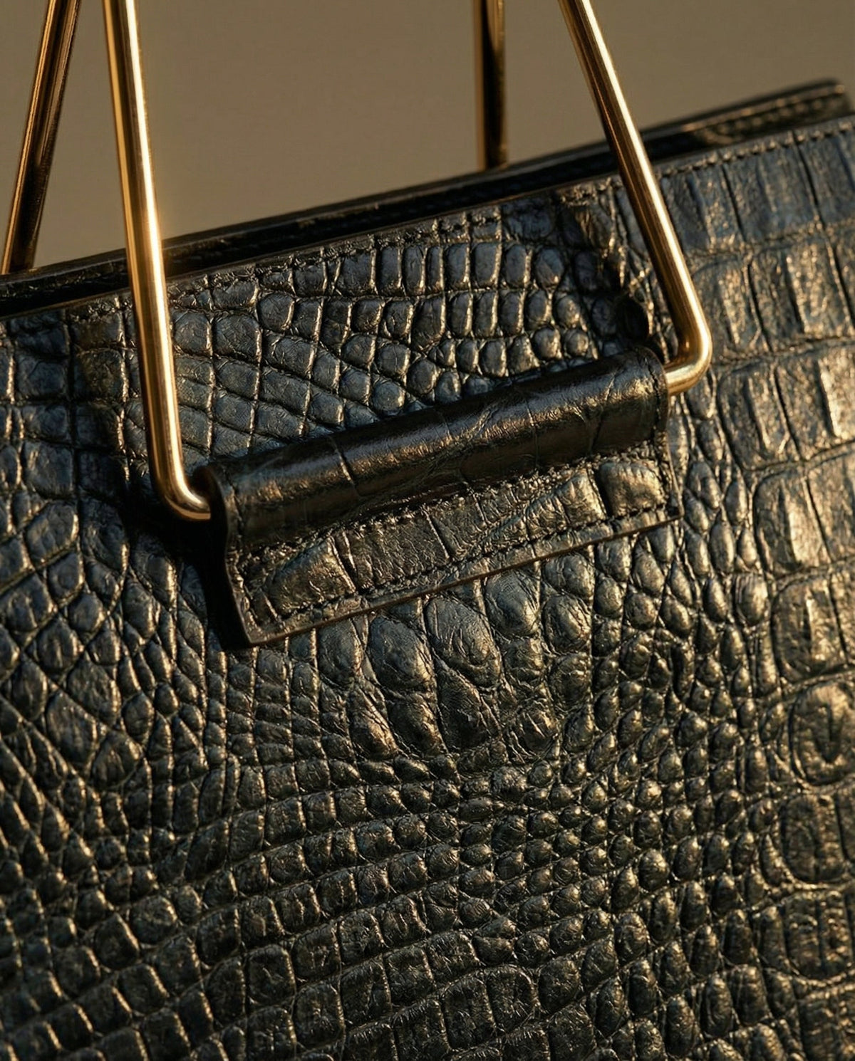 Close-up of steel handle on navy croc leather