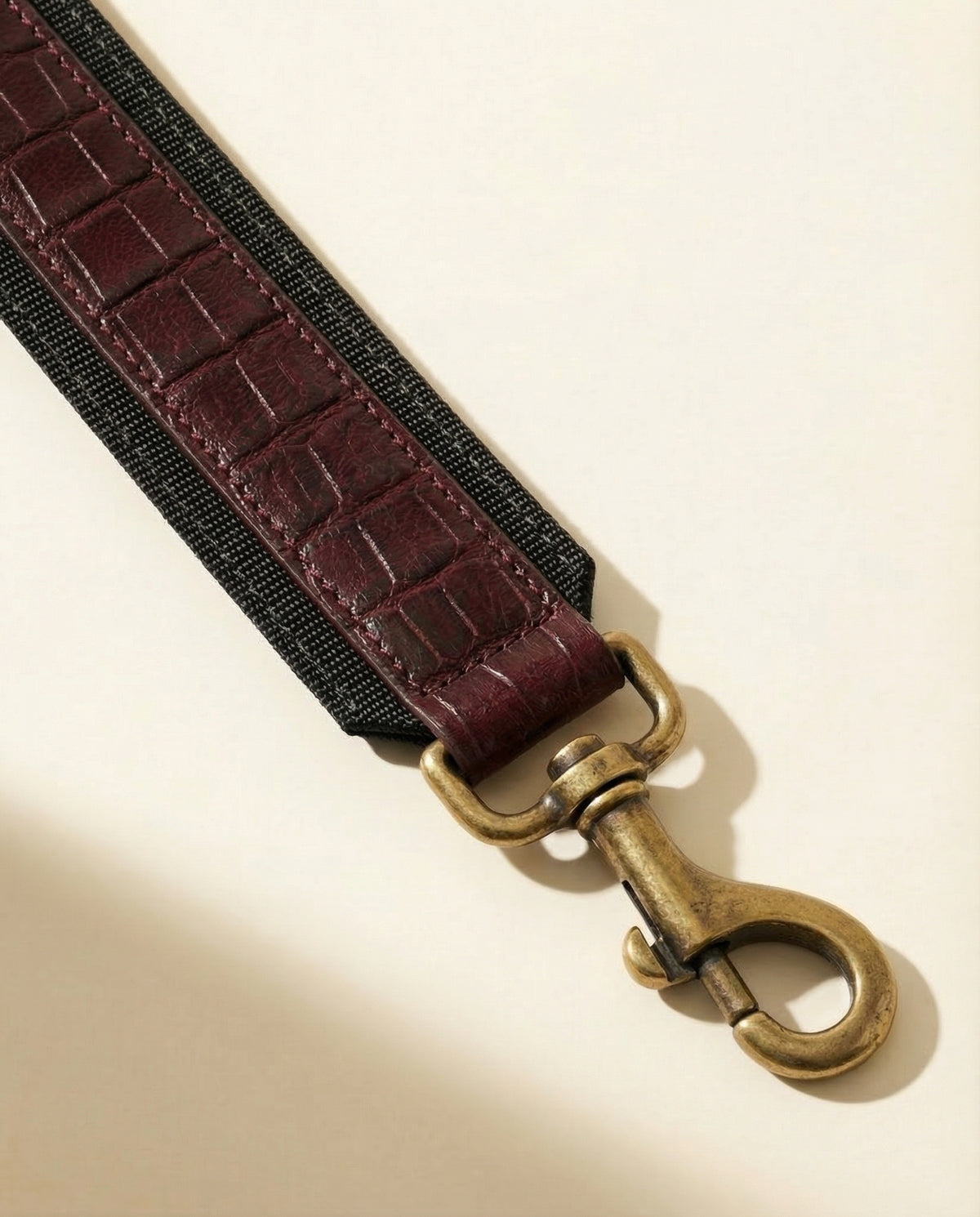 Close-up of shoulder strap clip on wine croc leather