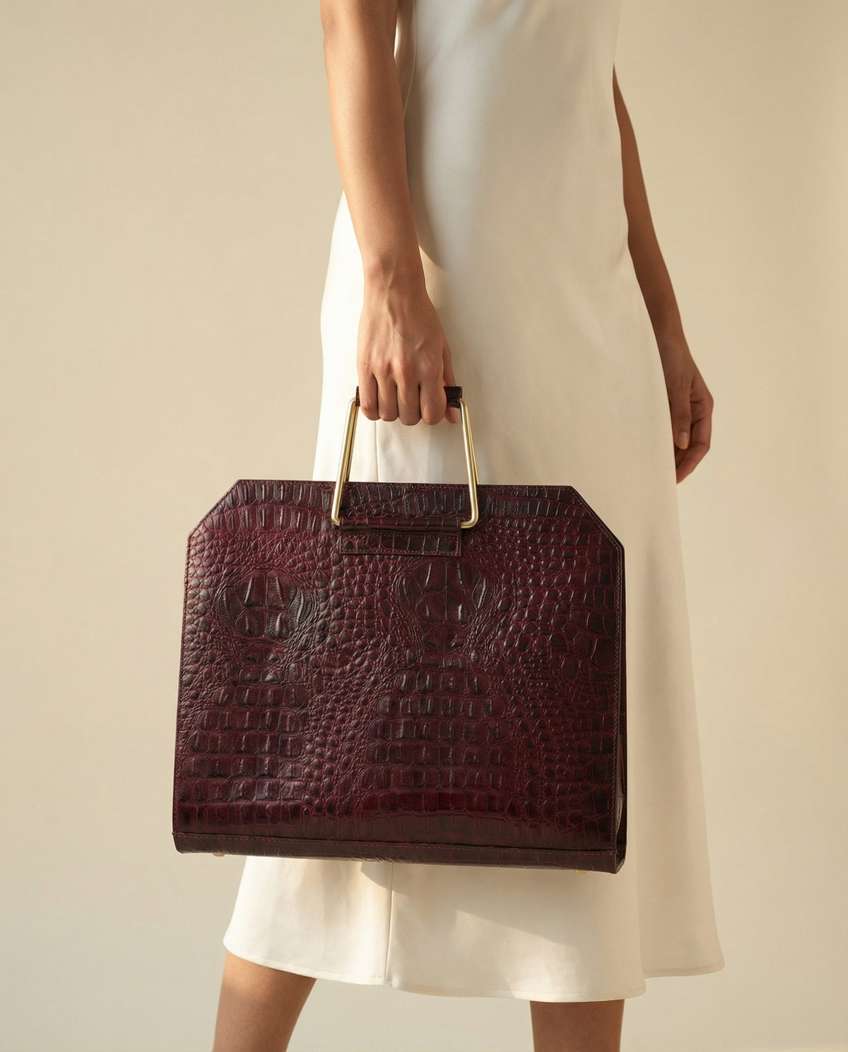 Wine croc leather laptop bag carried by hand