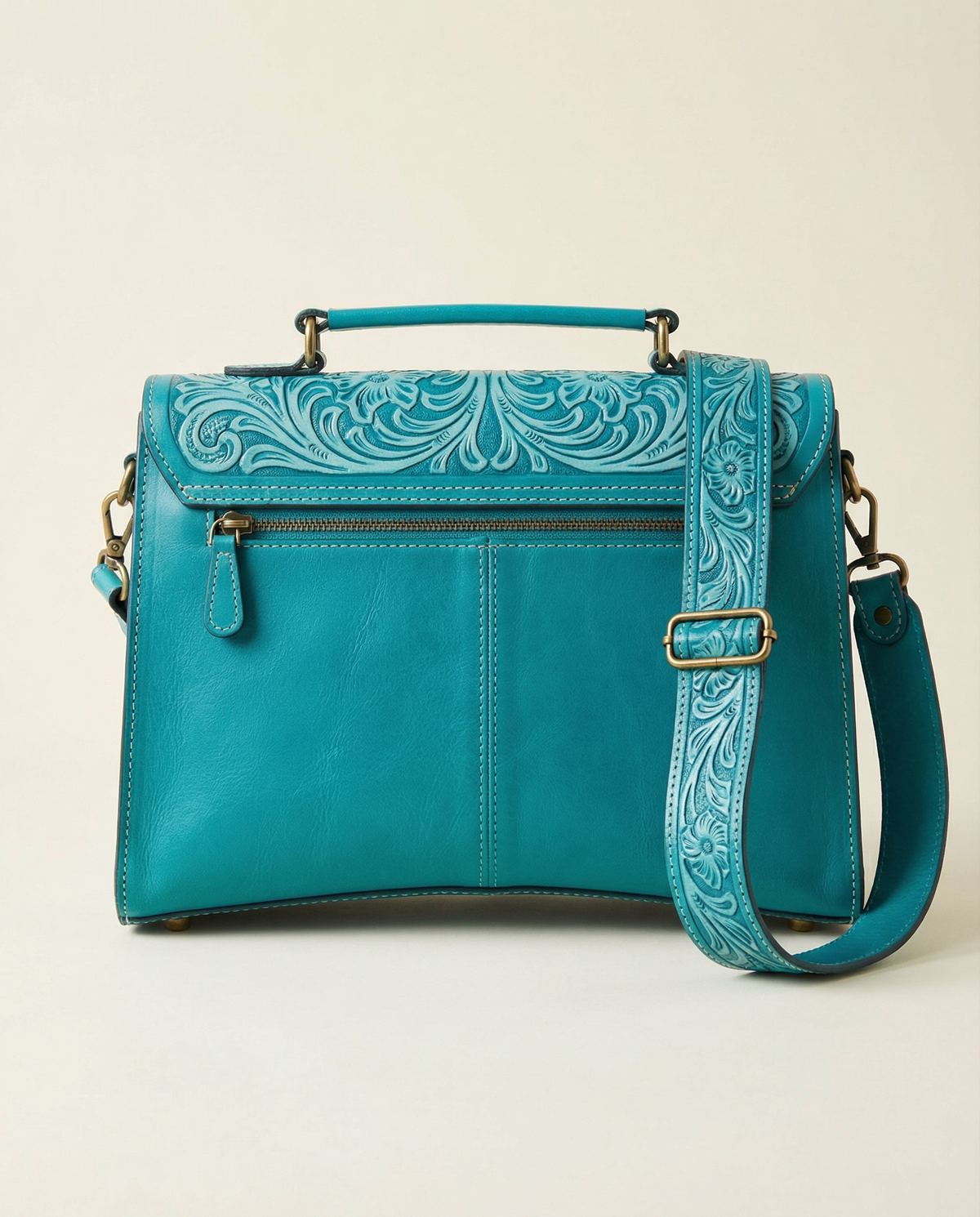 Back view of turquoise tooled leather satchel with zip pocket and tooled strap by Ya Qalbi