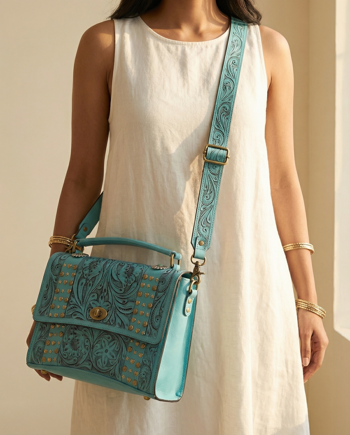 Turquoise tooled leather crossbody satchel worn by model by Ya Qalbi