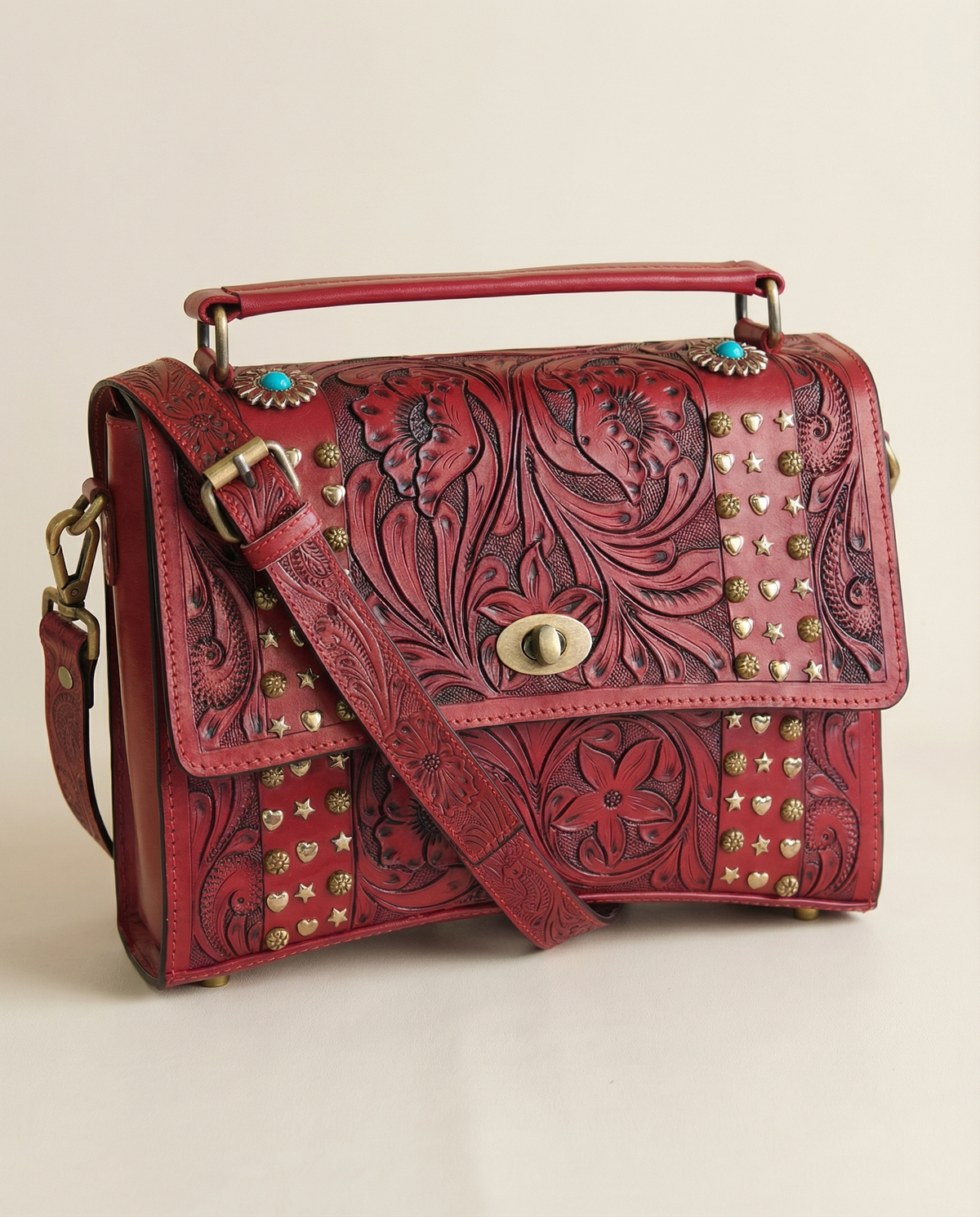 Red tooled leather satchel with crossbody strap attached by Ya Qalbi