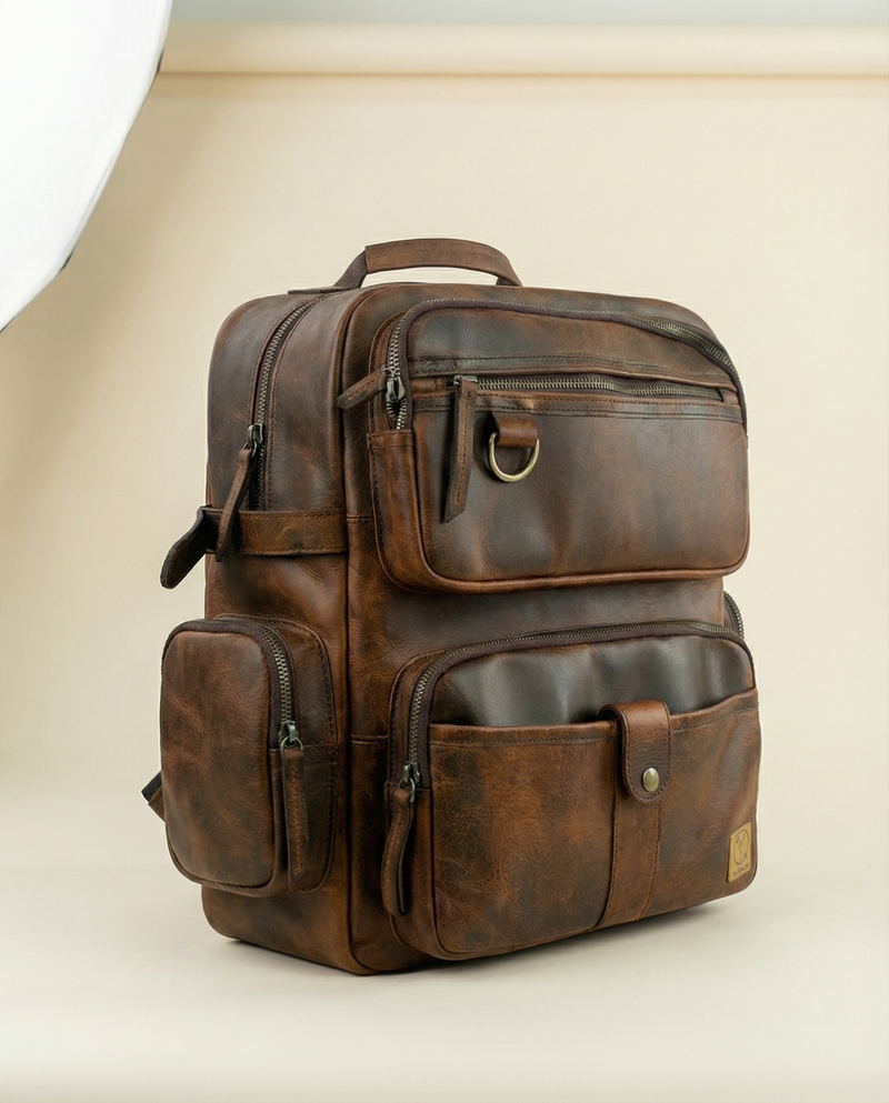 Handcrafted leather backpack with brass detail by Ya Qalbi